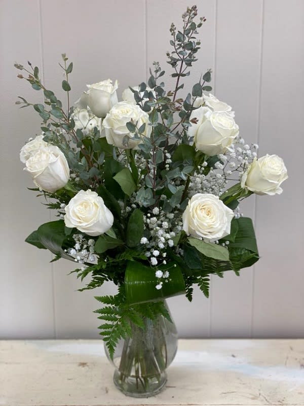 One Dozen White Roses One Dozen White Roses - Classic and Elegant, one dozen white roses arrive in a vase with accent flower and greenery