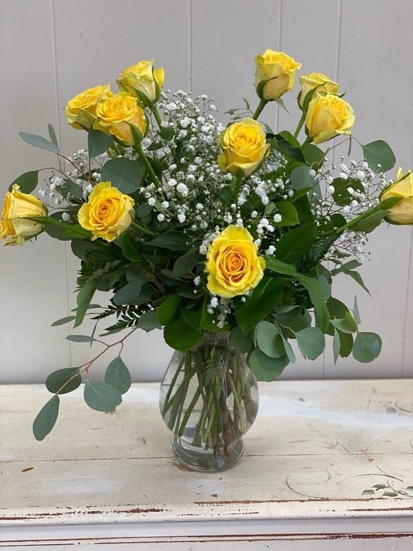 Sunshine Roses Sunshine Roses - 12 Yellow roses artistically arranged in a clear glass vase with accent flowers and greenery