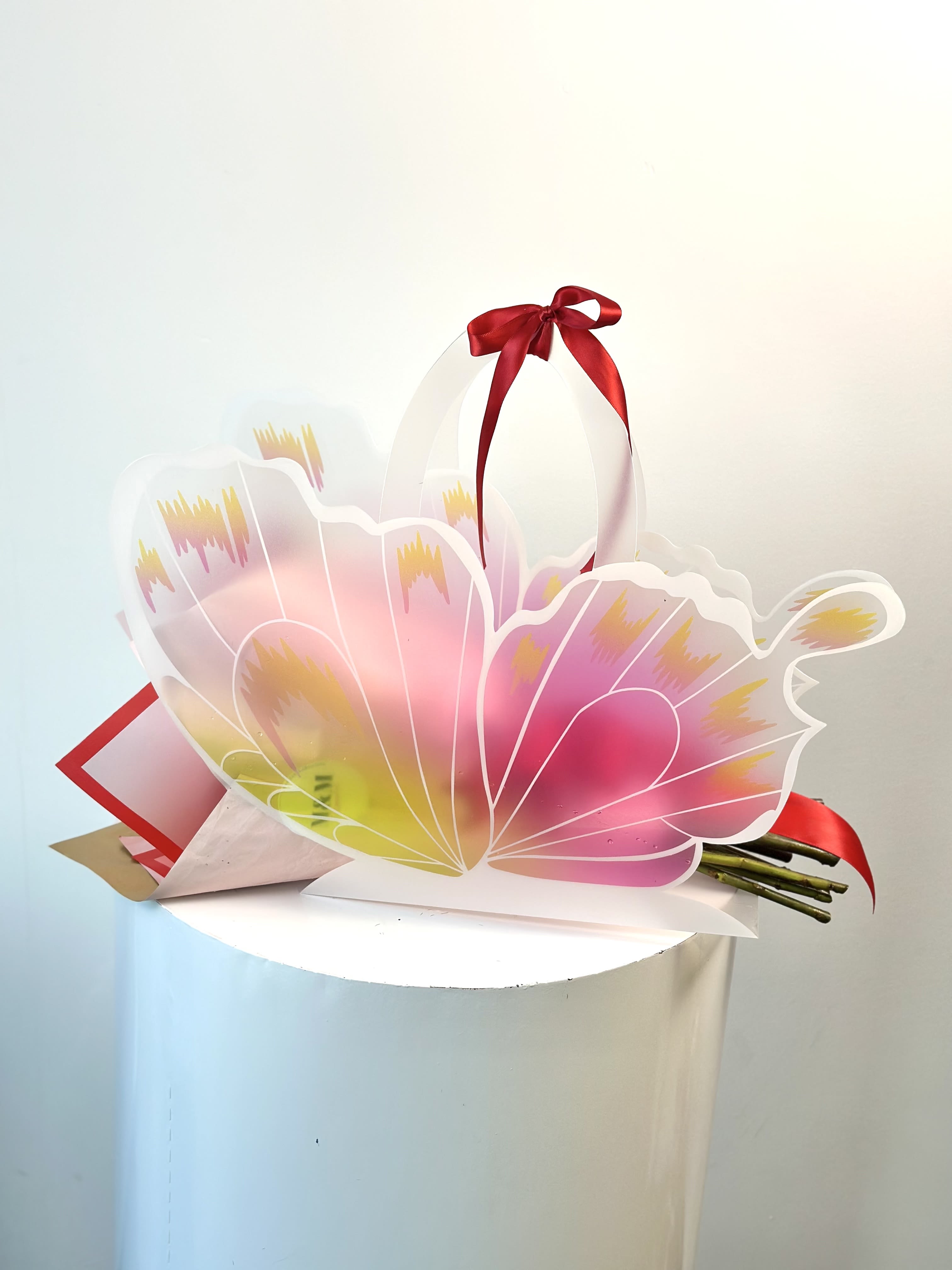 Wings of Romance - Let love take flight with our Wings of Romance arrangement.  This unique design features 15 roses in shades of red, pink and white, symbolizing passion, admiration, and purity.  Beautifully crafted into a butterfly-shaped hanger that delicately carry the bouquet.  Wings of Romance is a truly unforgettable gift that speaks from the heart.