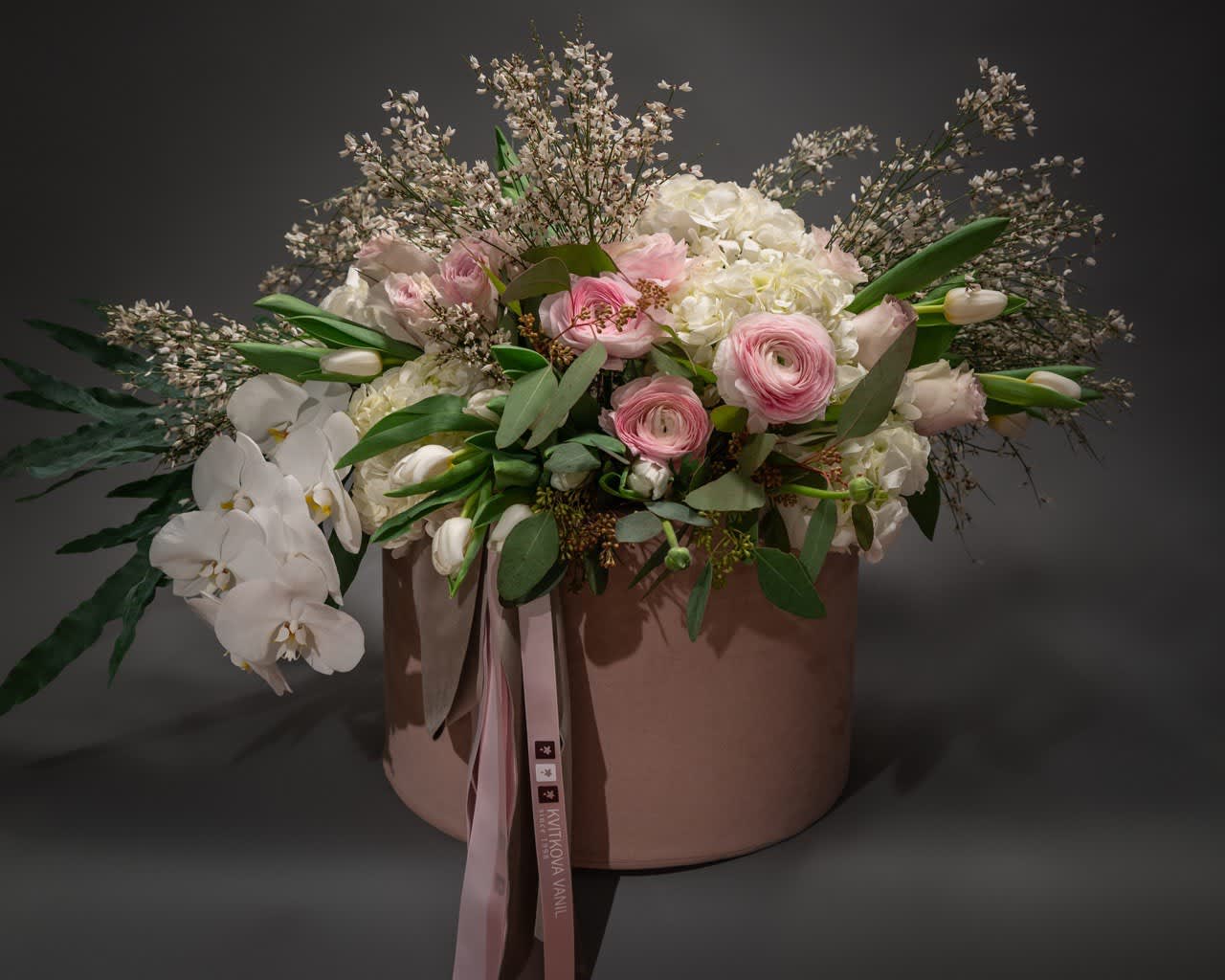 №189 Designer bouquet №189 Designer bouquet - Ethereal Bloom Collection Indulge in the exquisite beauty of our Ethereal Bloom Collection, a captivating ensemble that combines the delicate charm of Hydrangeas, the vibrant allure of Tulips, the timeless elegance of Ranunculus, and the exotic grace of Orchids. Each bloom is meticulously selected to create a harmonious arrangement that exudes sophistication and natural splendor. Whether you're celebrating a special occasion or simply want to add a touch of luxury to your space, the Ethereal Bloom Collection is a perfect choice. Elevate your surroundings with the enchanting fragrance and visual appeal of these premium flowers. Key Features: Hydrangea: Symbolizing heartfelt emotions and gratitude, these lush blooms add a sense of abundance and sincerity. Tulip: Representing perfect love, Tulips bring a burst of color and a touch of classic beauty to the arrangement. Ranunculus: With layers of delicate petals, Ranunculus signifies charm and radiates an air of refinement. Orchid: A symbol of luxury and exotic beauty, Orchids contribute an element of sophistication and intrigue. Transform any space into a haven of natural elegance with our Ethereal Bloom Collection. Handcrafted to perfection, this arrangement promises to be a visual delight and a testament to the finer things in life. Order now and let the timeless beauty of these blooms elevate your moments.