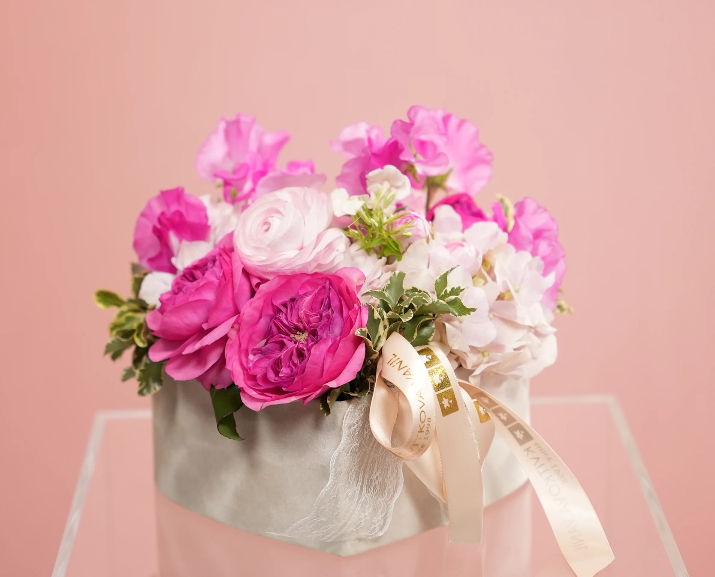 №154 Designer Bouquet - Indulge your mother with our &quot;Raspberry Blush&quot; bouquet, an exquisite arrangement crafted exclusively for Mother's Day. This stunning bouquet features a delightful combination of ranunculus, roses, sweet peas, and pink hydrangeas, elegantly arranged in shades of pink with hints of raspberry.  The &quot;Raspberry Blush&quot; bouquet exudes femininity and grace, symbolizing the warmth and tenderness of a mother's love. Each delicate bloom is carefully selected to convey admiration and appreciation, with the ranunculus and roses adding a touch of elegance, while the sweet peas and hydrangeas infuse the arrangement with a soft and romantic allure.  Handcrafted with precision and care, the &quot;Raspberry Blush&quot; bouquet is a true reflection of your affection and gratitude for your mother. Its vibrant colors and delicate fragrance will brighten her day and fill her heart with joy and happiness.  Order now to surprise your mother with the enchanting beauty of our &quot;Raspberry Blush&quot; bouquet, and let its timeless elegance express your love and appreciation in the most heartfelt way possible.