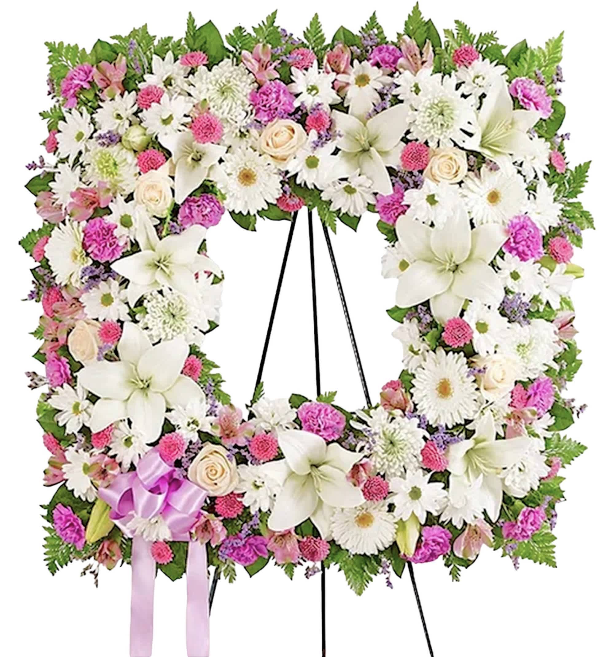 Sentimental Solace Square Wreath - Lavender and White - Offer solace with a sentimental arrangement for the services. The square wreath features soothing-hued blooms &amp; greenery for a lush, full presentation. A photo can be displayed in the center, creating a unique and beautiful tribute to a cherished loved one. Appropriate for the funeral home, memorial service, or gravesite.  White roses, Asiatic lilies, gerbera daisies, mums and daisy poms, lavender alstroemeria, button poms &amp; carnations, purple limonium &amp; greenery.  EASEL INCLUDED 66&quot;H Orientation: One-Sided *If you would like to add a ribbon with a sentiment for an additional $10 each *For larger photos, we recommend upgrading to the deluxe or premium. Item #NF-1116  FLORIST-TO-DOOR Same day flower delivery on most orders placed online by 12 pm or 10 am on weekends PST.  BLOOM DETAILS Roses Asiatic Lilies Gerbera Daisies Alstroemeria Carnations Daisy-Mums Button-Mums Cushion-Mums Limonium Greenery  The Standard Arrangement is approx. 31&quot;H x 31&quot;W without stand (SHOWN) (66&quot;H with easel) 18&quot;D The Deluxe Arrangement is approx. 33&quot;H x 33&quot;W without an easel (68&quot;H with easel) 20&quot;D The Premium Arrangement is approx. 35&quot;H x 35&quot;W without an easel (70&quot;H with easel) 22&quot;D  INSTRUCTIONS: 1.) Please have the business name of the funeral home, address &amp; phone number. 2.) Please have the first name &amp; last name of the deceased. 3.) Please have the start time of the services.  NINFA'S FLOWERS 2405 WHITTIER BLVD. LOS ANGELES, CA. 90023