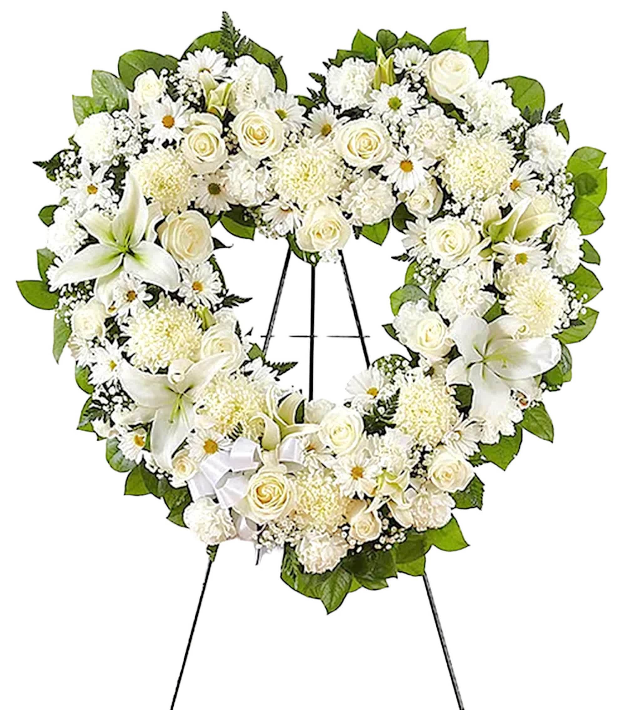 Always Remember Floral Heart Tribute - White - The enduring love you feel for them will keep them always remembered. This sentiment is best captured with a standing, open heart-shaped arrangement in all white. Handcrafted with an assortment of white blooms, it is a magnificent tribute fitting for the funeral services, memorial service, or gravesite.  DETAILS Open, heart-shaped arrangement of all-white Roses, Hybrid Lilies, Chrysanthemums, Carnations, and Daisy Poms; accented with baby’s breath and soft, lush greenery.  EASEL INCLUDED Orientation: One-Sided *If you would like to add a ribbon with a sentiment for an additional $10 each. Item #NF-1006  FLORIST-TO-DOOR Same day flower delivery on most orders placed online by 12 pm or 10 am on weekends PST.  BLOOM DETAILS Roses Hybrid Lilies Chrysanthemums Carnations  Daisy Poms Filler Greenery  The Standard Arrangement is approx. 26&quot;H x 28&quot;W without easel. (SHOWN) The Deluxe Arrangement is approx. 28&quot;H x 30&quot;W without an easel. The Premium Arrangement is approx. 30&quot;H x 32&quot;W without an easel.  INSTRUCTIONS: 1.) Please have the business name of the funeral home, address &amp; phone number. 2.) Please have the first name &amp; last name of the deceased. 3.) Please have the start time of the services.  How to place an order?  1. You can place an order directly on this secure website. OR 2. You can call in your order by dialing: (323) 262 - 9238. OR 3. You can visit our store (appointment recommended 323.262.9238)  NINFA'S FLOWERS 2405 WHITTIER BLVD. LOS ANGELES, CA. 90023 
