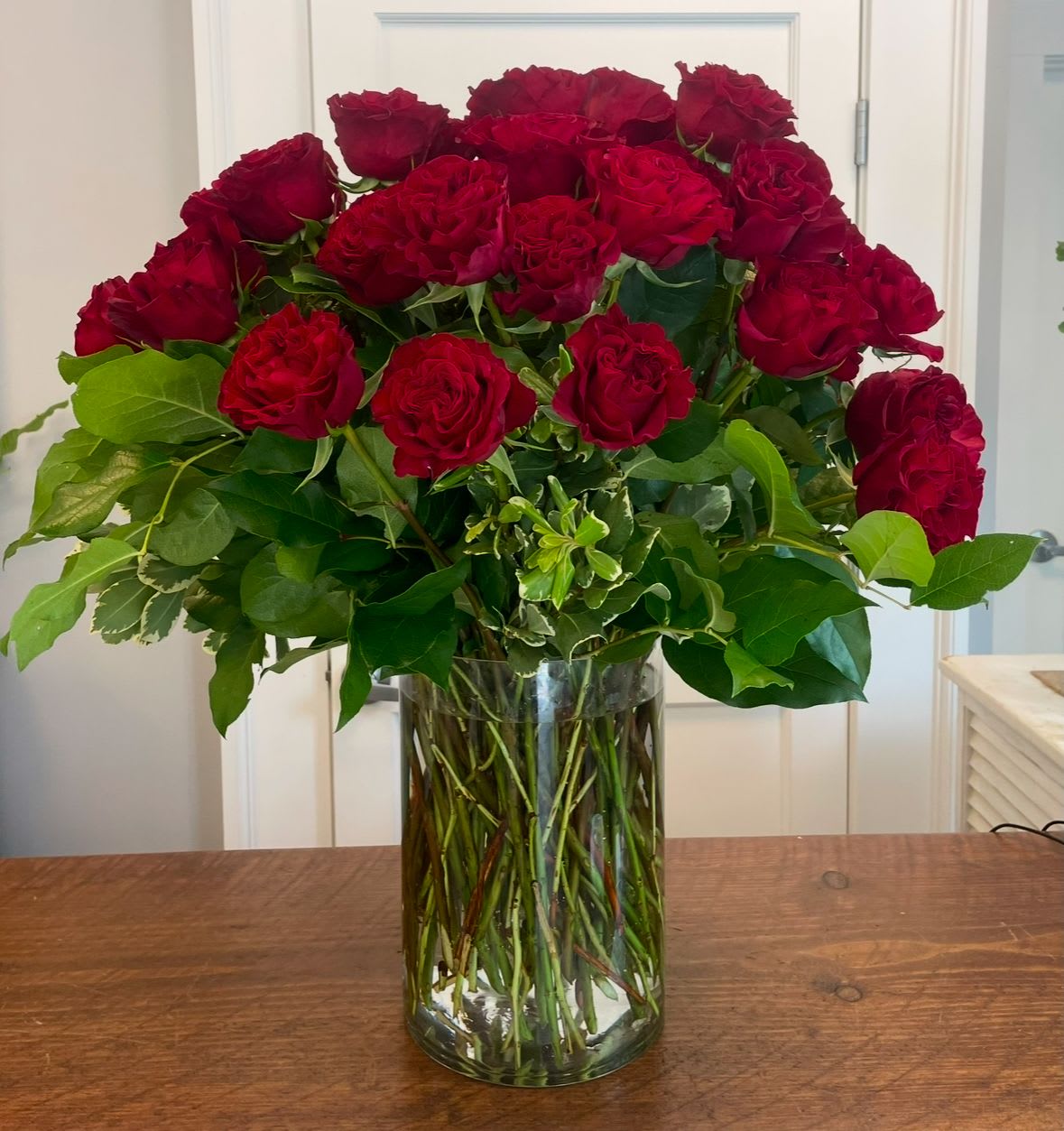 Simply Roses - Roses and greens in a clear vase