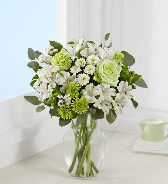 Serene Green™ - Send a gift of serenity to someone special in your life. Inspired by the beauty of nature, our charming bouquet is designed with the freshest blooms, in delicate shades of green and white. Arranged in a classic gathering vase tied with raffia, it’s a thoughtful gift to help celebrate, support, comfort or simply connect.