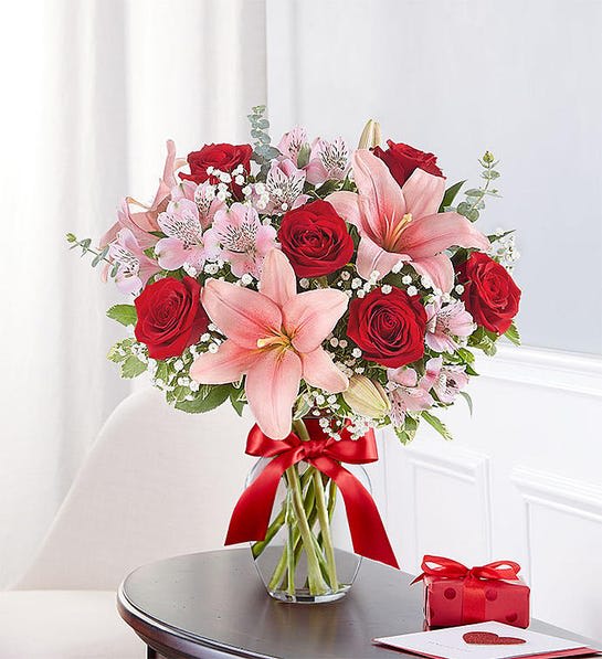 Key To My Heart® clear vase Key To My Heart® clear vase - All-around arrangement with red roses; pink Asiatic lilies and Peruvian lilies (alstroemeria); accented with baby’s breath, spiral eucalyptus and assorted greenery Artistically designed in a clear glass vase tied with a red satin ribbon;