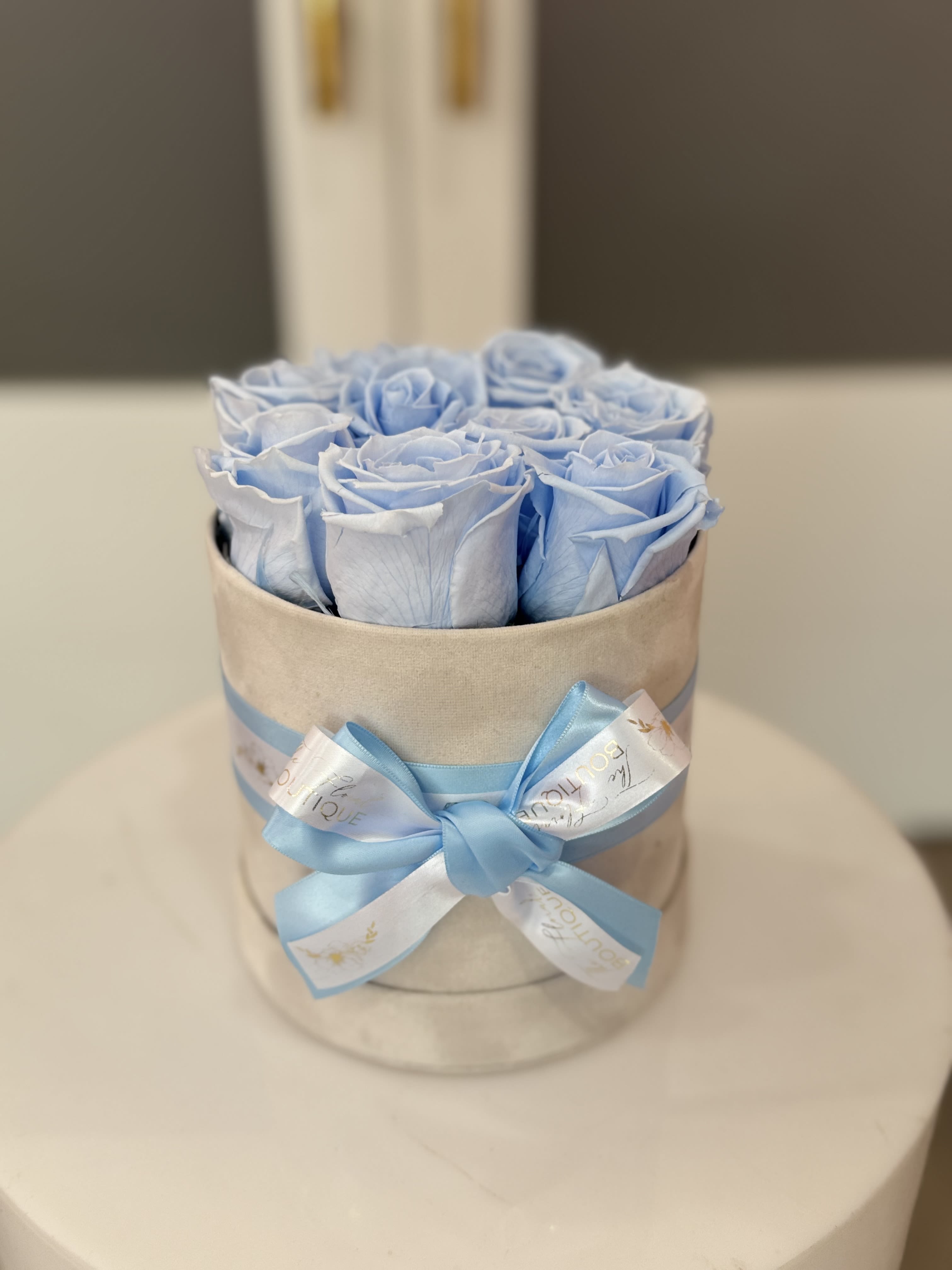 Preserved 9 Rose Box  - Make a statement of elegance with this stunning arrangement of 9 preserved Blue roses. Encased in a sleek, high-quality box, these roses are expertly preserved to maintain their vibrant color and soft texture for up to a year or more. Perfect for romantic gestures, anniversaries, or simply to show someone how much they mean to you, this arrangement combines beauty and longevity. • Features: • 9 premium preserved blue roses • Long-lasting freshness without the need for watering • Chic, reusable box for elegant display  Gift the ultimate symbol of enduring love with this luxurious rose box.