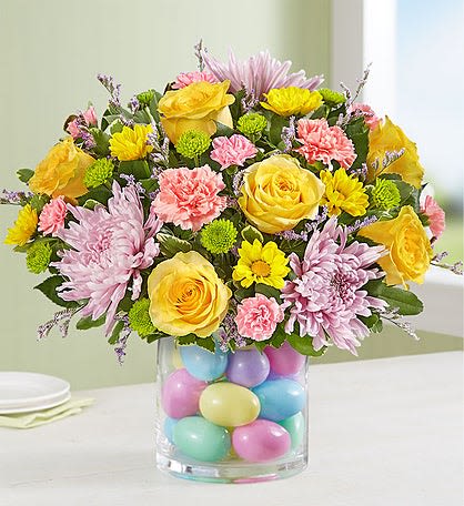 Easter Egg-Stravaganza - All round arrangement  Rosa’s yellow  Carnation pink Green button  Daise lavander Solidago  Egg plastic  