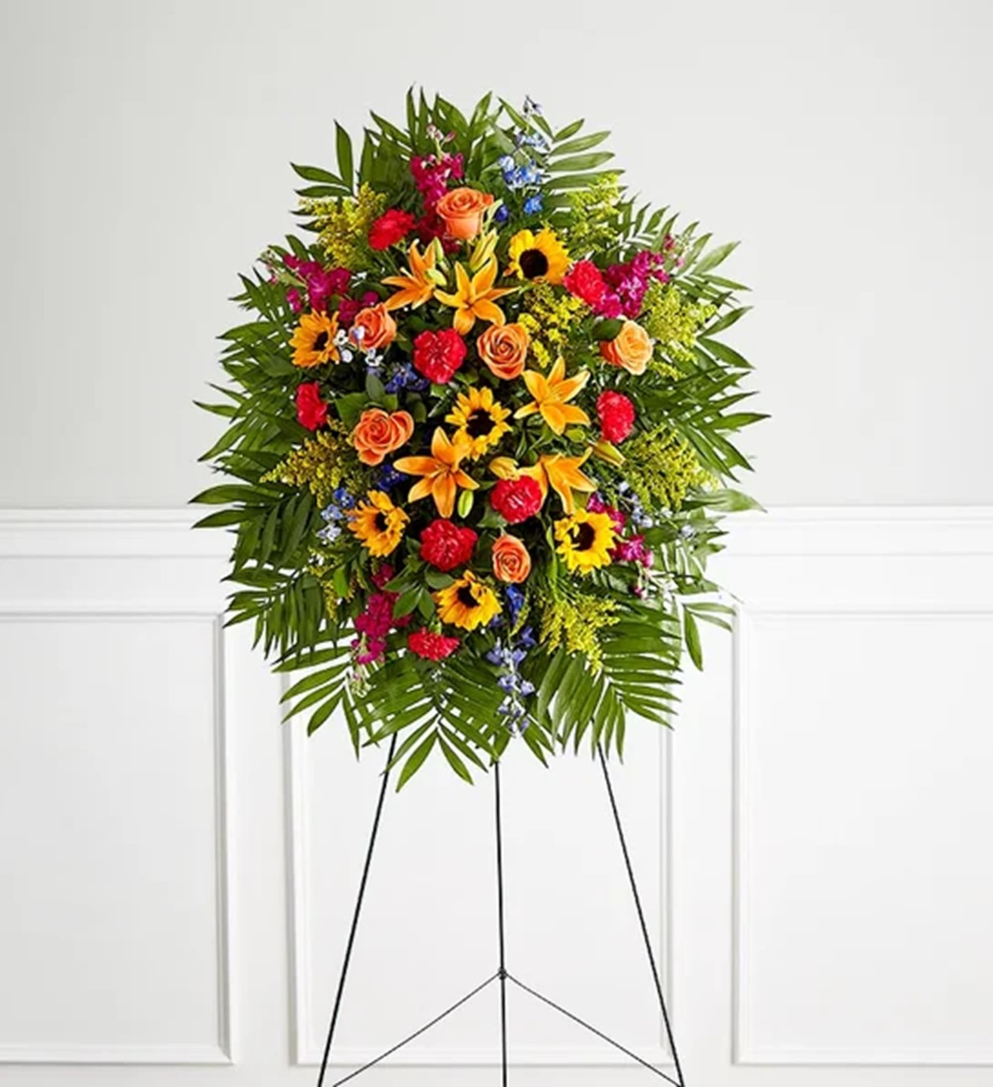 Vibrant Funeral Standing Spray - Their joy and exuberance will always be remembered. The classic standing spray arrangement was designed to capture that lively spirit. Elegantly crafted for a lush, full presentation, this vibrant mix of blooms creates a memorable tribute to someone who was truly one-of-a-kind. Appropriate for the funeral home, memorial service, or gravesite.  DETAILS One-sided standing spray arrangement with orange roses and Asiatic lilies, golden sunflowers, blue delphinium, fuchsia stock, hot pink carnations and yellow solidago; accented with assorted greenery  EASEL INCLUDED Orientation: One-Sided *If you would like to add a ribbon with a sentiment for an additional $10 each. Item #NF-1320  FLORIST-TO-DOOR Same day flower delivery on most orders placed online by 12 pm or 10 am on weekends PST.  BLOOM DETAILS Roses Asiatic Lilies Sunflowers Delphinium Stock Carnations Solidago Greenery  The Standard is approx. 42&quot;H x 30&quot;W without stand The Deluxe is approx. 46&quot;H x 34&quot;W without stand The Premium is approx. 50&quot;H x 38&quot;Wwithout stand  INSTRUCTIONS: 1.) Please have the business name of the funeral home, address &amp; phone number. 2.) Please have the first name &amp; last name of the deceased. 3.) Please have the start time of the services.  NINFA'S FLOWERS 2405 WHITTIER BLVD. LOS ANGELES, CA. 90023