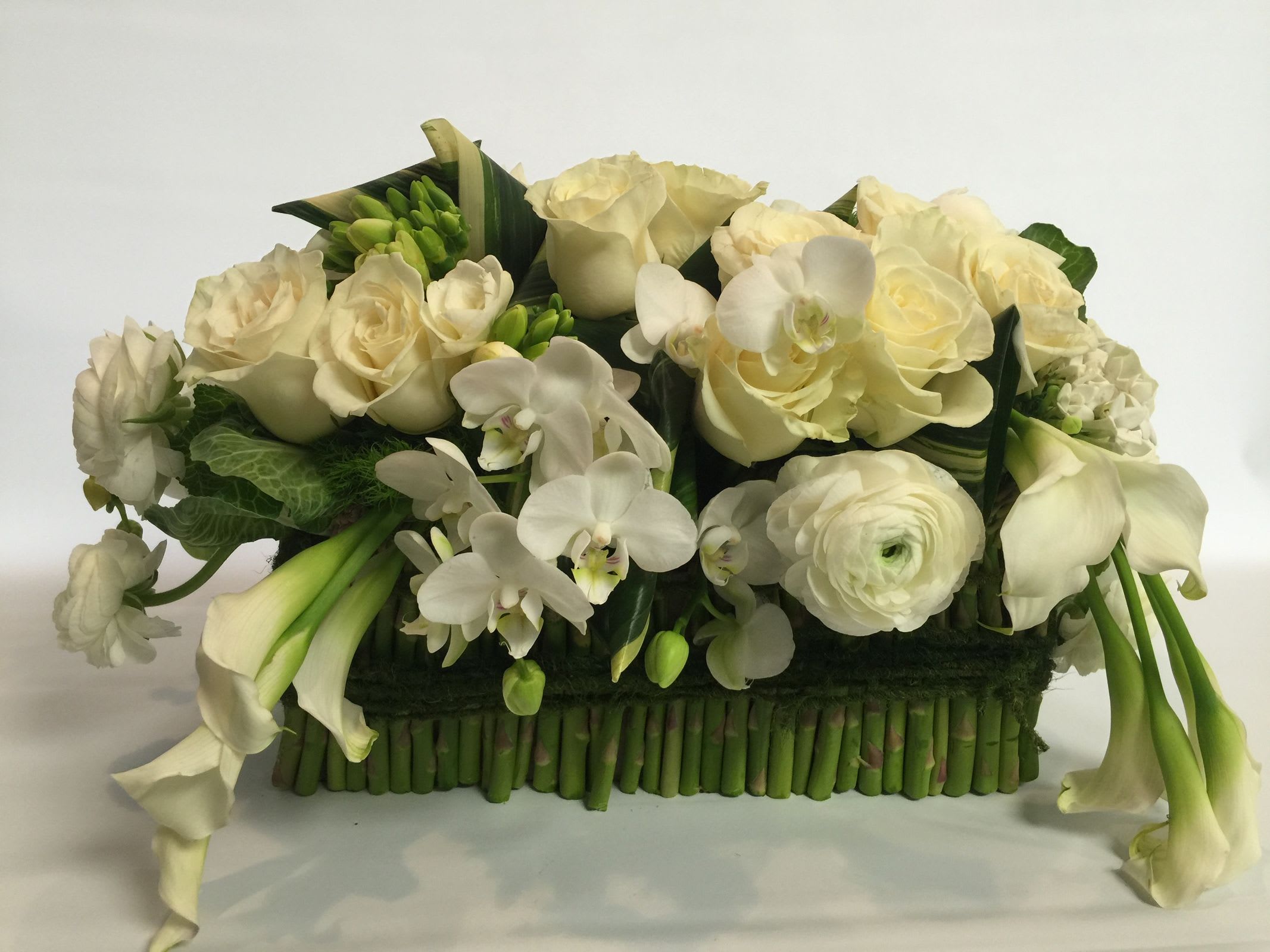 Asparagus white botonical - Asparaagus covering the vase of this artistic floral Coutour which is filled with Calla lily,Ranunculus,roses and orchid. Need a special gift?  At Ultimate Floral Designs, all of our arrangment are customizable and made fresh in order to capture the alluring beauty of flowers