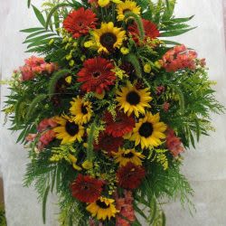 Sunflower Standing Spray - Beautiful sunflower, gerber daisy, and greenery with added seasonal flowers standing funeral spray