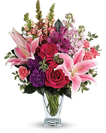 Morning Meadow Morning Meadow - Make a statement ! Hand-delivered in a shapely glass vase, this sumptuous arrangement of roses and lilies is a lavish way to celebrate a special day, or surprise someone... just because! Hot pink roses, pink spray roses, pink oriental lilies, purple alstroemeria, purple carnations, light pink stock and pink snapdragons are arranged with pitta negra and camellia leaves. Delivered in a clear Couture vase.