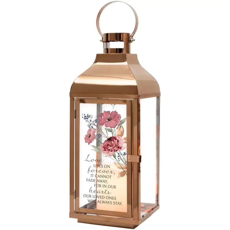 Love Lives Lantern Love Lives Lantern - About this product These lanterns are made with a high quality metal finish and uv printed glass artwork with sentiment. The flameless LED candle features a built in automatic timer 6 hours ON/18 hours OFF. 3 AAA batteries are included. These lanterns are intended for indoor use only. Lantern Reads: "Love lives on forever, it cannot fade away, for in our hearts our loved ones will always stay." • Dimensions: 5.5 x 5.5 x 17.5 in
