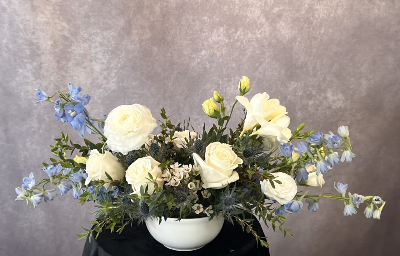 Ocean Blue - A customer favorite with the season’s freshest, most beautiful flowers and greenery, designed in a high end ceramic vase. This design is popular for anniversaries, birthdays, or just because!  Flowers and greenery may vary due to seasonal availability, but that’s part of the charm! Our creative designers will substitute with the freshest high end product available- some grown in our very own garden!- and create something beautiful.  *Have a special request?* Let us know in the special instructions section during checkout.