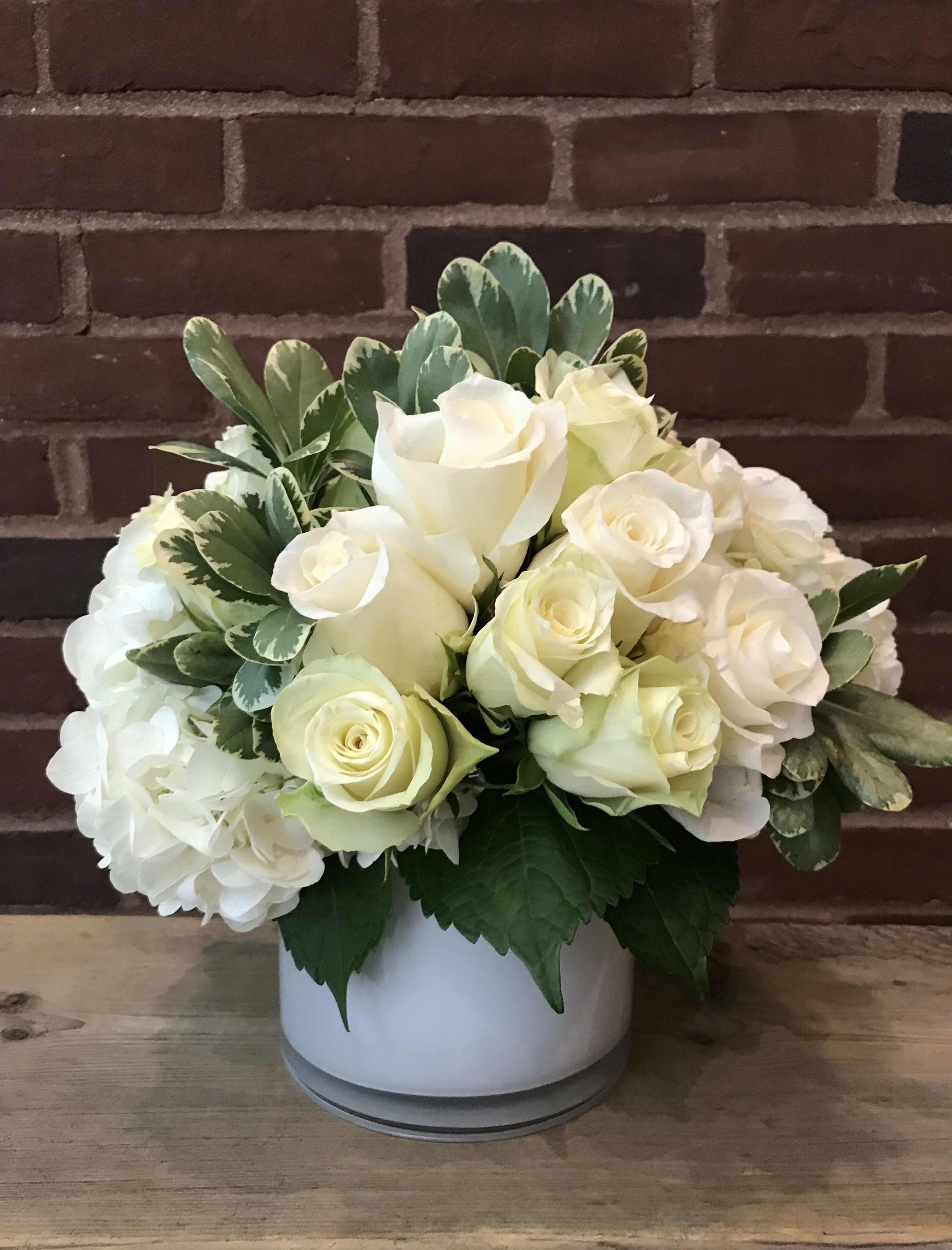 Simply Chic Simply Chic - With different shades of white hydrangea and roses this arrangement is elegantly chic and versatile. Show that you care and value your relationship by sending the very best. For all and any occasion.