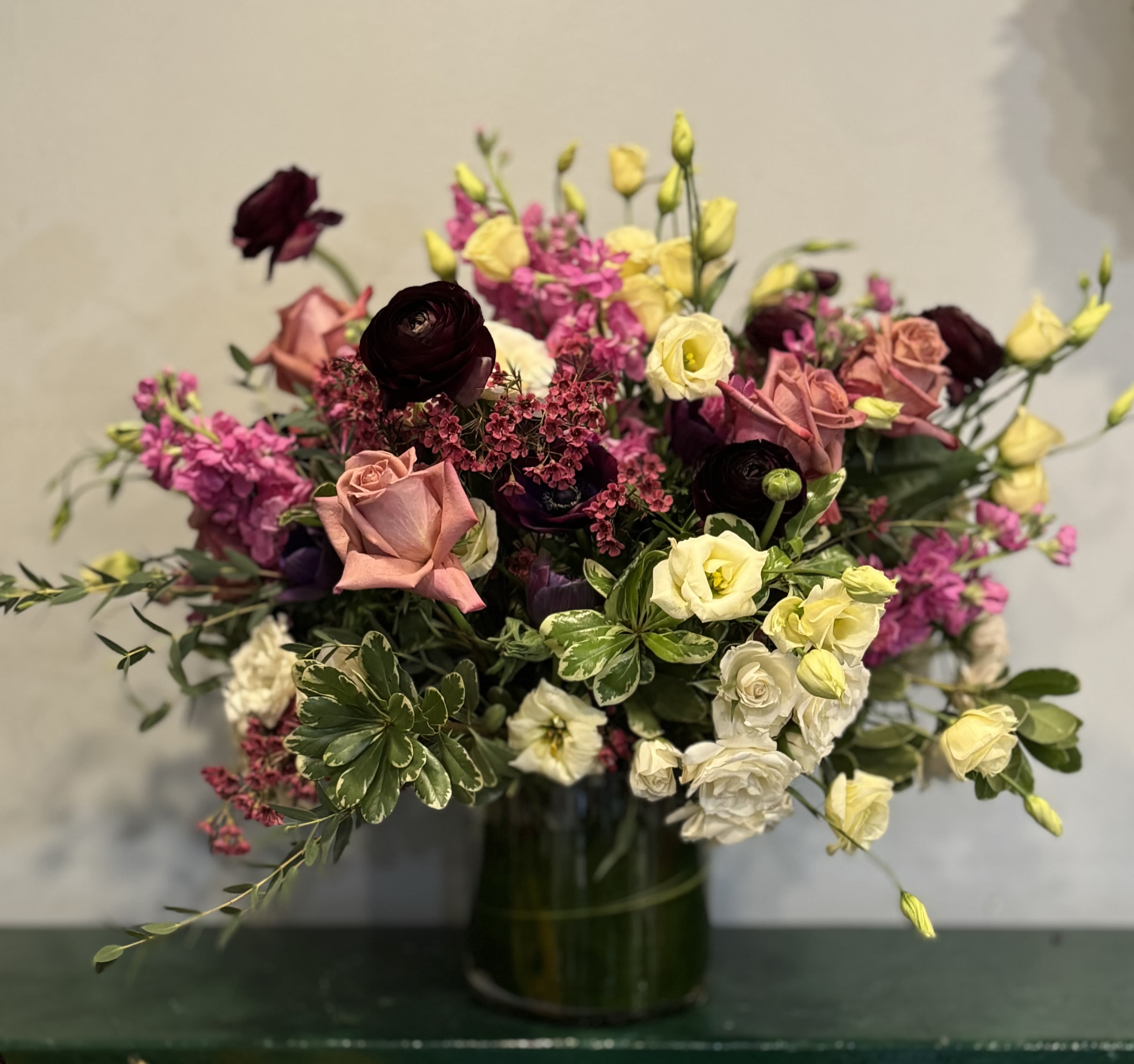 Symphony Of Blooms Symphony Of Blooms - Let this floral piece take over your senses! As with a musical symphony each bloom plays off the other creating harmony and balance. Color palette may vary depending on availability.