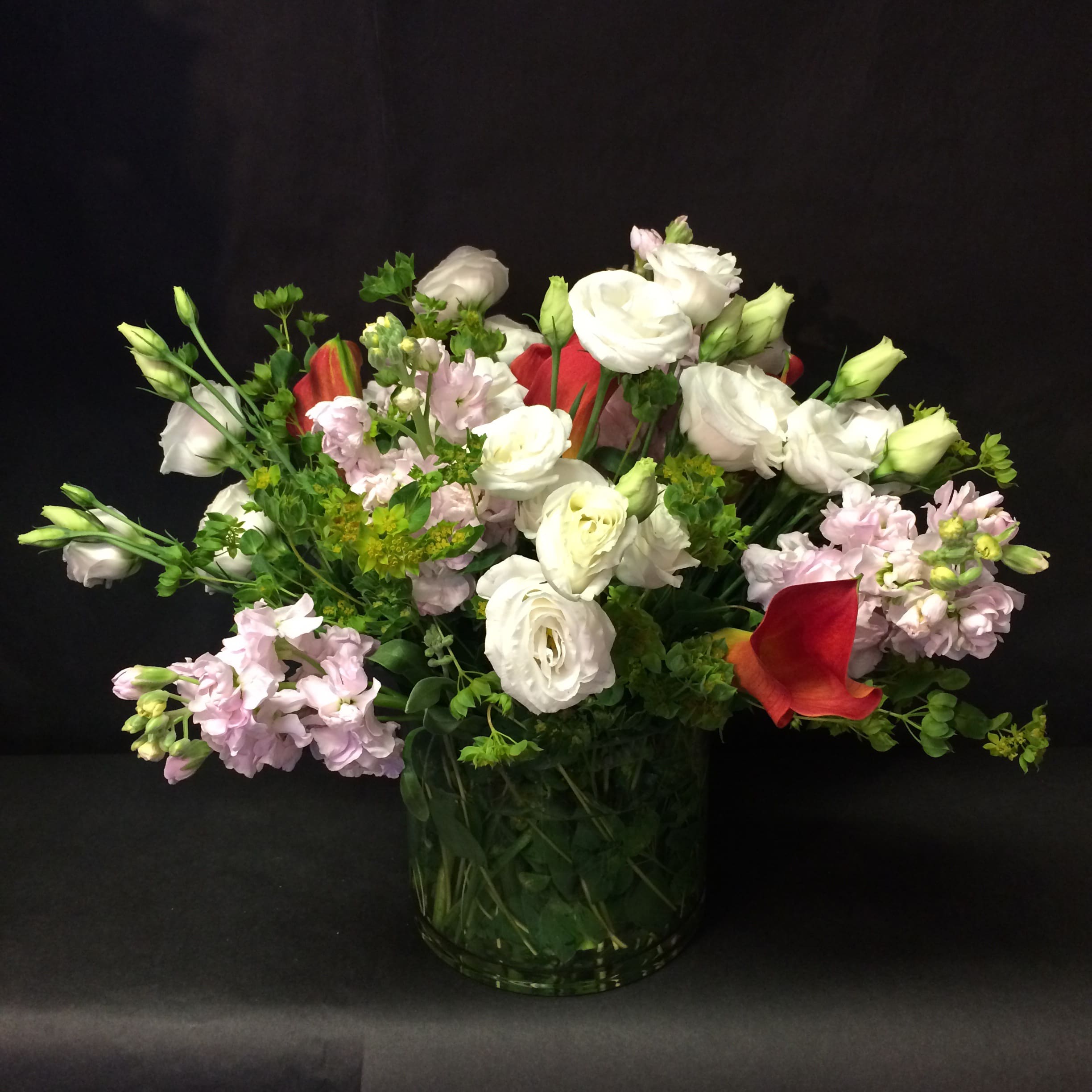 Watercolor by Design Watercolor by Design - A whimsy array of soft hues consisting of stock, buplorum, and lisianthus with just a faint pop of bold!