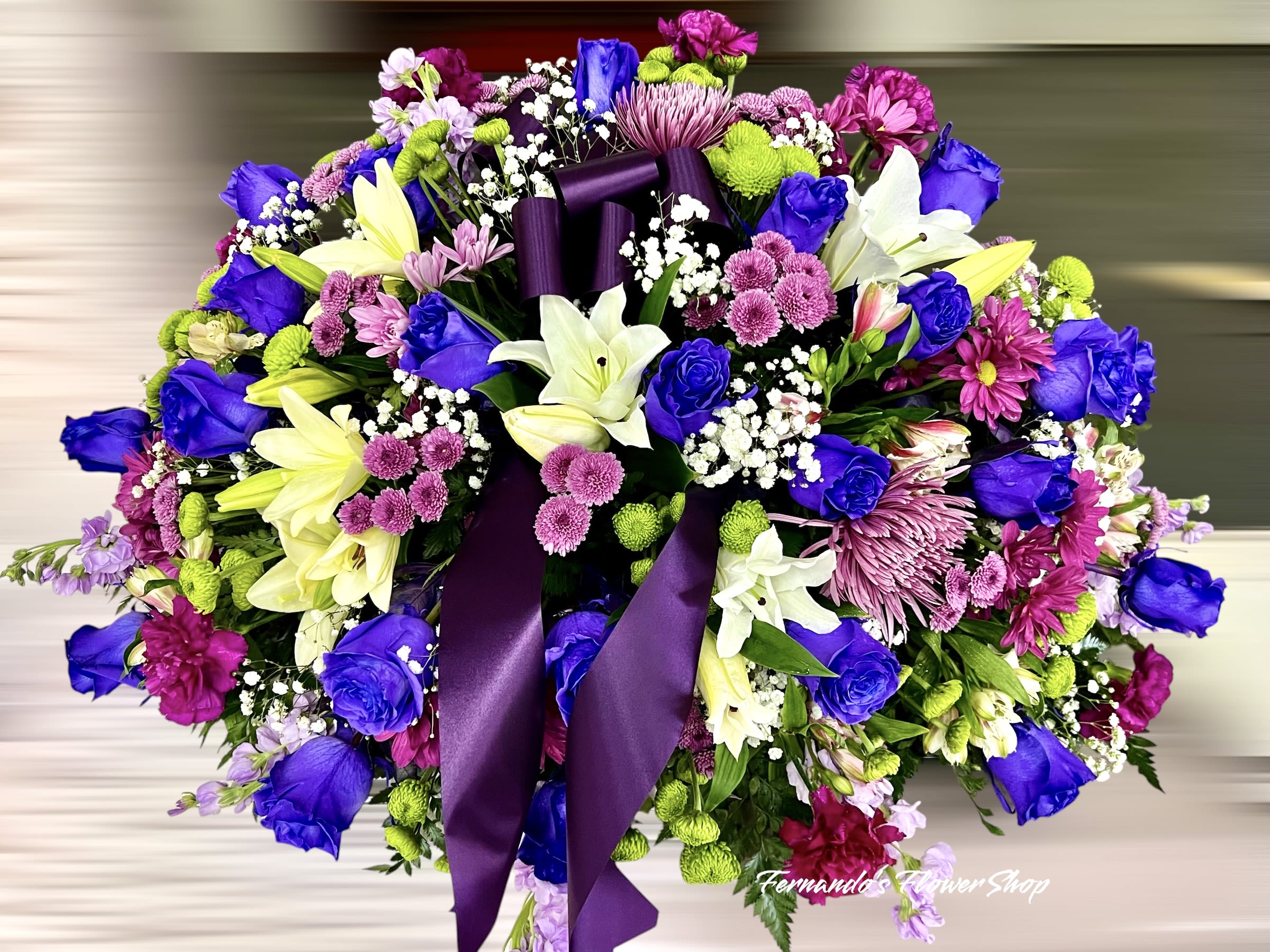 Beaty of Purples - “A stunning casket spray designed to honor a beautiful life. Vibrant hues of purple, pink, and white come together in this elegant arrangement, symbolizing love, remembrance, and peace. Crafted with care by Fernando’s Flower Shop.  #FloralTribute #CasketSpray #FernandosFlowerShop”