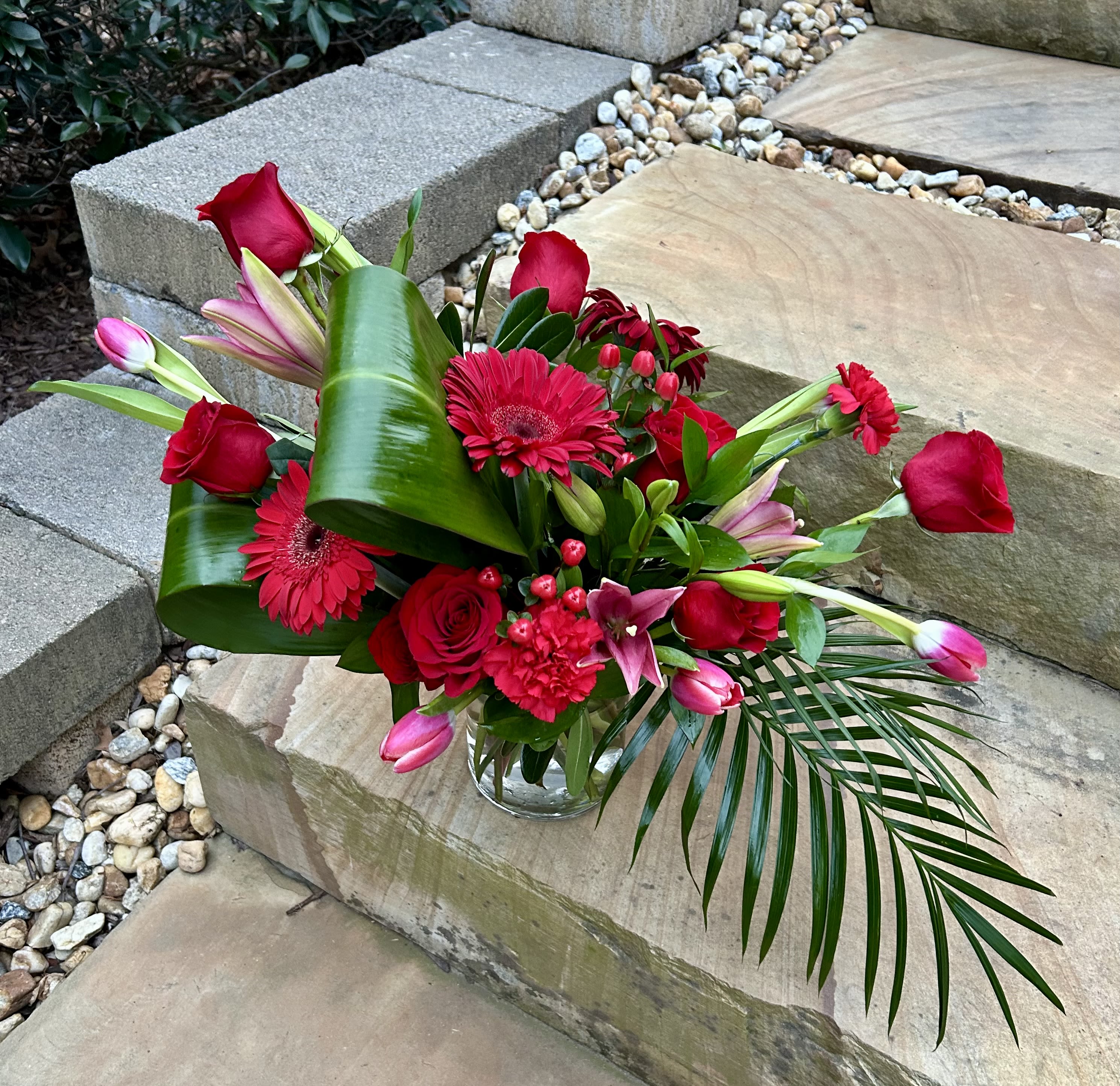 Red Paradise Red Paradise - A tropical-like arrangement of red flowers and large greens to bring a little paradise to your home!