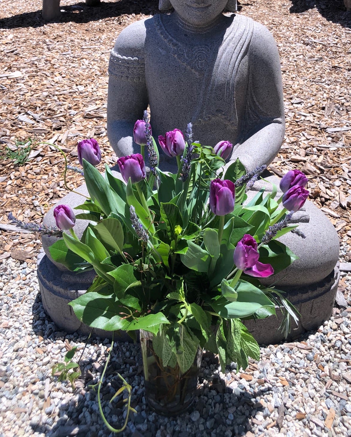 Tulip Tranquility - An arrangement of just tulips and fresh lavender with lush greens such as gardenia foliage, mint, rosemary as well as special touches of jasmine or ivy to set them off in a tall glass vase....Perfect anytime!