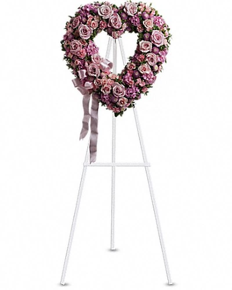 Rose Garden Heart - A tender and classic tribute to a precious life. Heartfelt emotions and sympathies find delicate expression here. Lovely flowers such as light pink roses, hydrangea and miniature carnations mix with lavender button spray chrysanthemums. Approximately 18&quot; W x 19&quot; H Orientation: One-Sided All prices in USD ($)