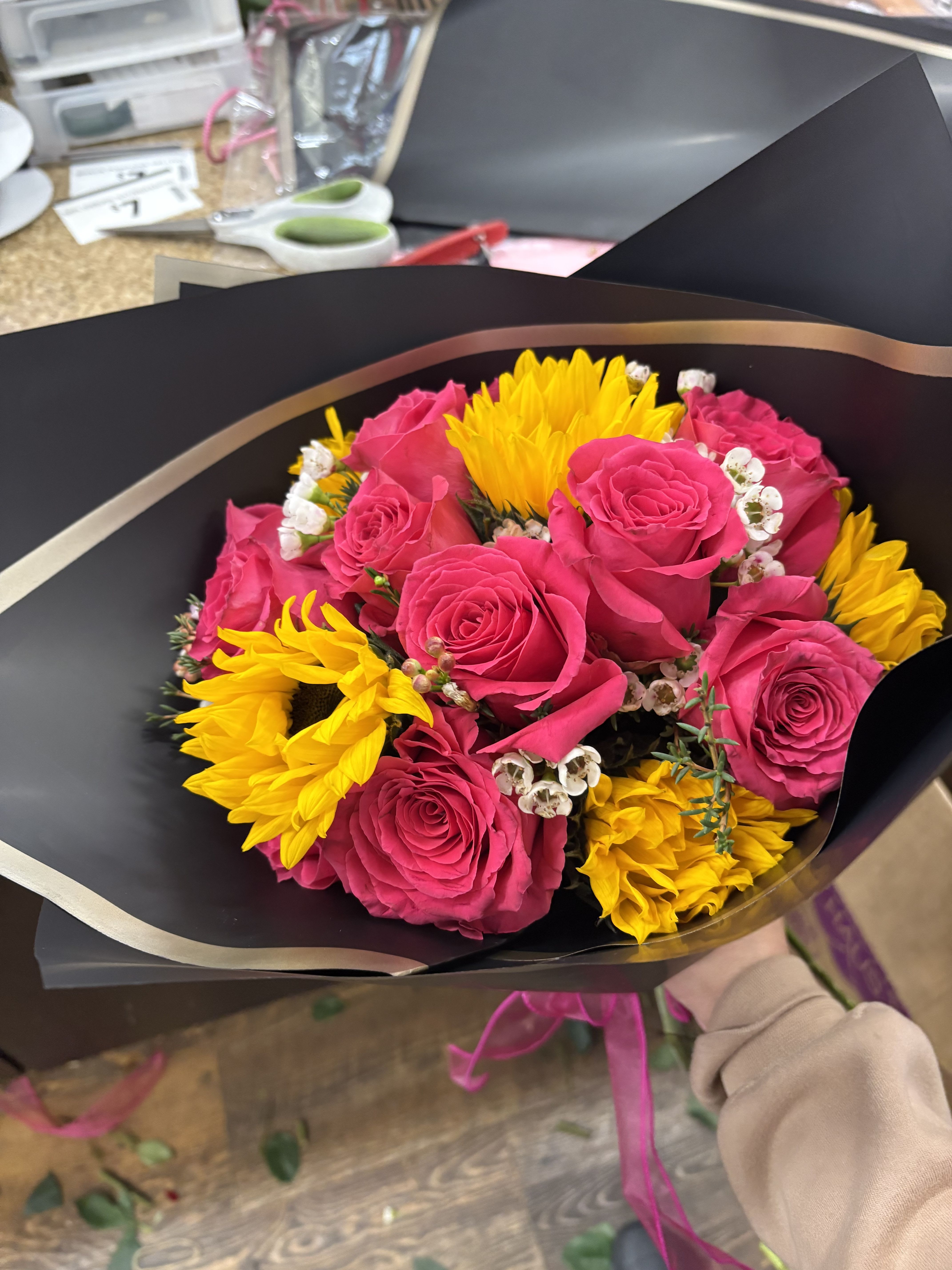 pretty pink bouquet pretty pink bouquet - dozen pink roses with greenery, and sunflowers wrappen in black tissue paper with pink bow…