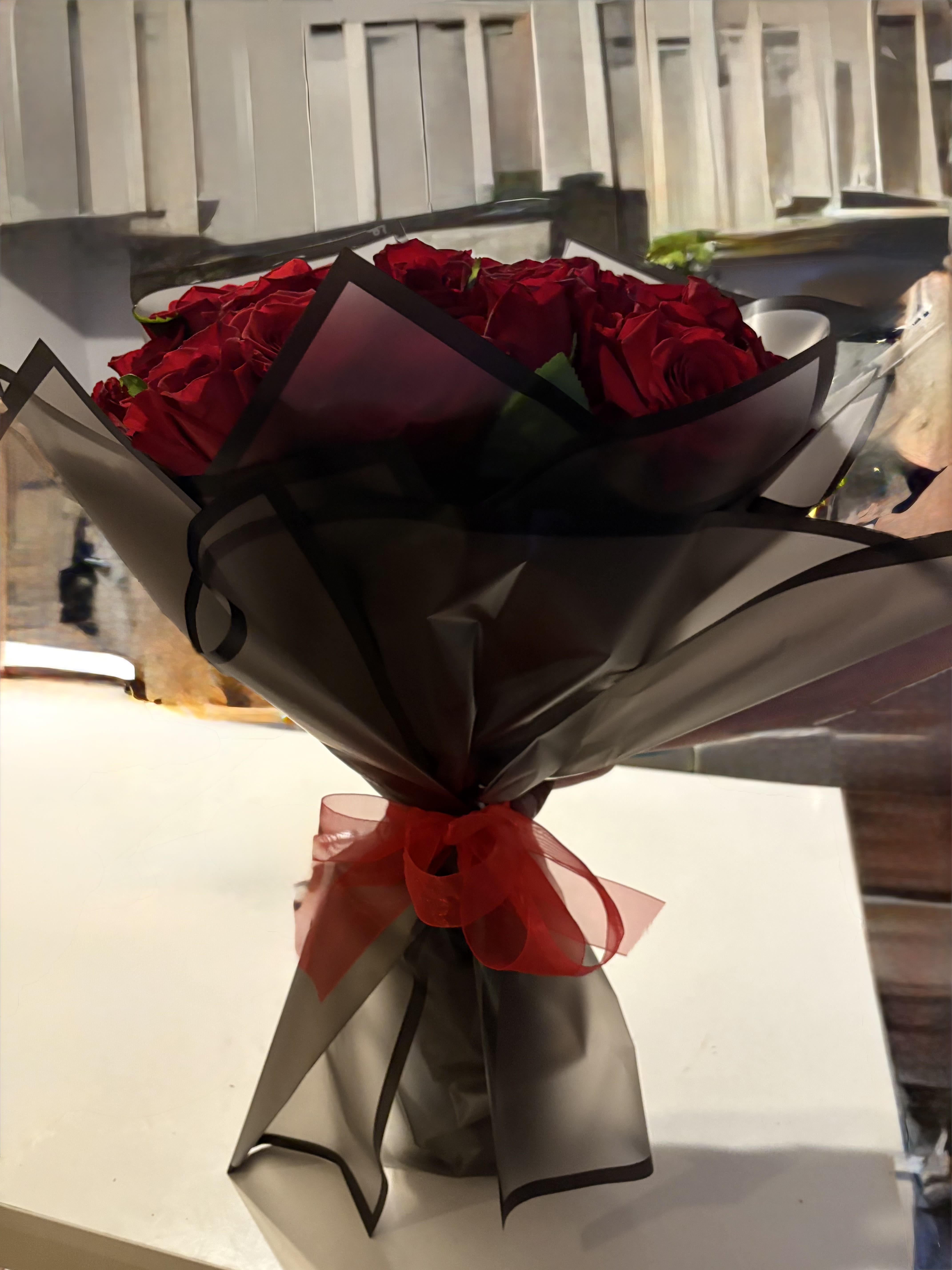 Red and Black Elegance - 48 Hand tied roses wrapped in an elegant black craft paper tide with a red bow around.