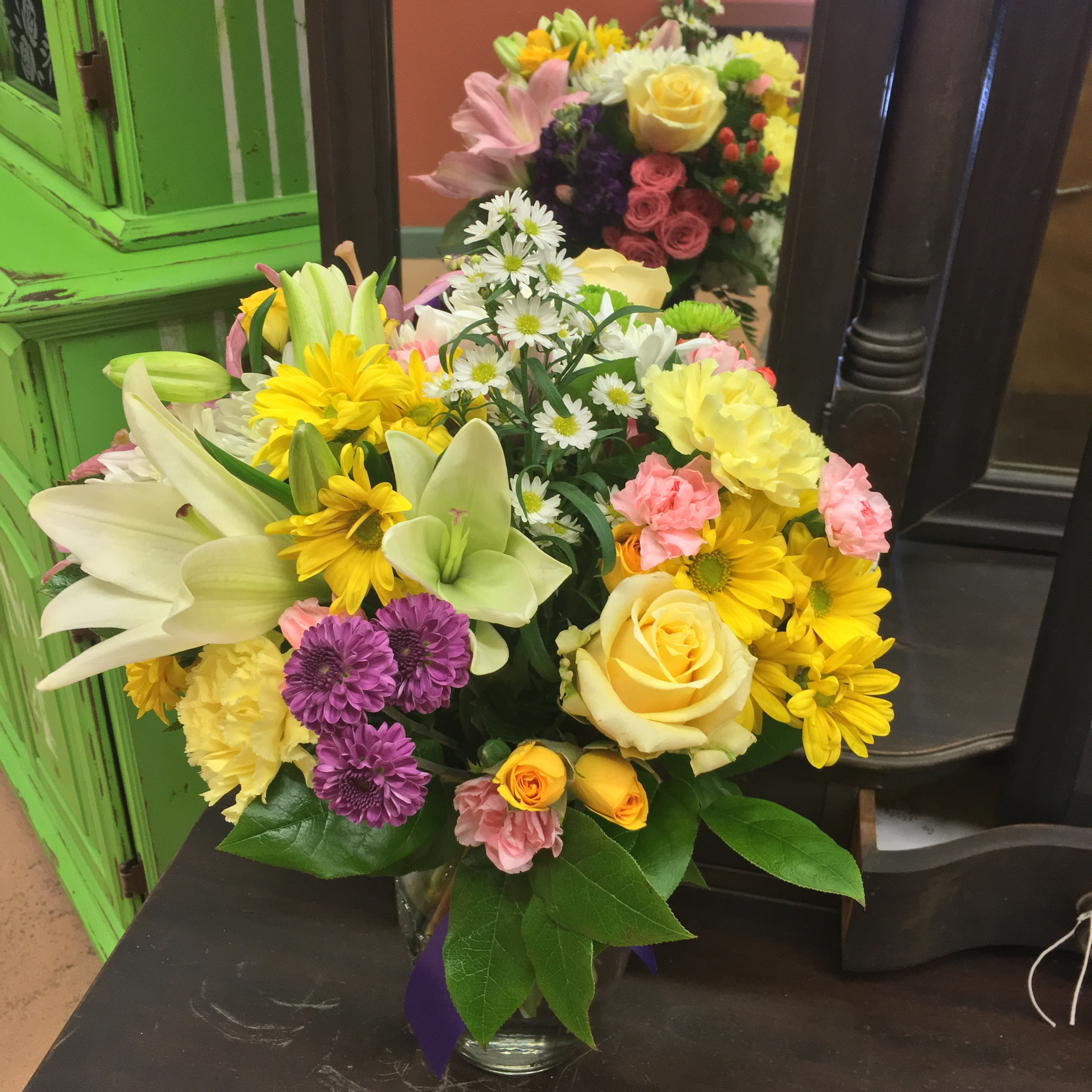 Mom's Favorite Mom's Favorite - When you know you're Mom's favorite, you don't want to disappoint! This beautiful arrangement will be perfect to show Mom, just how much you love her. Packed full of all of Mom's favorite flowers including, but not limited to: Lilies, Roses, Miniature Roses, Carnations, fragrant Stock flower, a mix of Chrysanthemum and more, adorned with a Ribbon to match. Want to make sure Mom get's the best of the best? Upgrade to Deluxe and we'll be sure to use our most premium flowers! *Colors May Vary