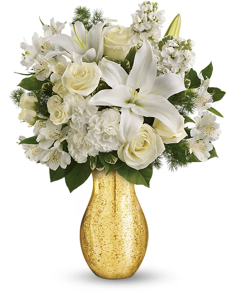 Teleflora's Dream with Me - The stuff that dreams are made of! This ethereal bouquet of snow white flowers in a golden mercury glass vase has a touch of vintage charm -and more than a touch of timeless romance! This beautiful bouquet includes an array of white blooms including roses, spray roses, oriental lilies, alstroemeria, carnations and stock -all accented with fresh green lemon leaves, variegated pittosporum and ming fern. Delivered in a beautiful golden mercury glass vase to give a glorious presentation.
