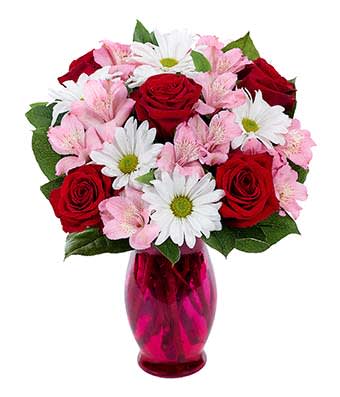 Sweet Nothing Bouquet - It's almost as if romantic sweet nothings are being whispered in your special someone's ear, letting them know how much they mean to you. Expressing those thoughts of love is a beautiful combination of red roses, pink alstroemeria and white daisy poms, artistically placed in a lovely fluted vase.