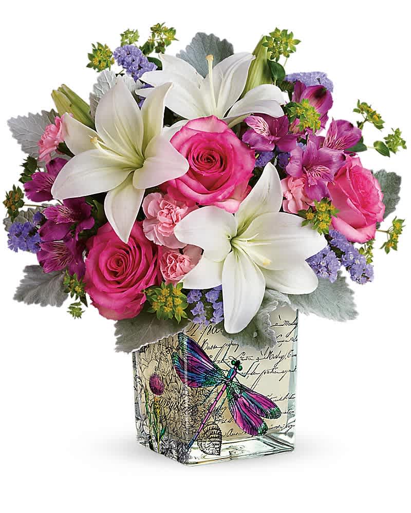 Teleflora's Garden Poetry Bouquet Teleflora's Garden Poetry Bouquet - A poem in flowers, just for mom! Give her a Mother's Day gift she'll never forget with this European-inspired cube vase, filled with fresh lilies and roses. White asiatic lilies, hot pink roses, lavender sinuata statice, and purple alstroemeria are arranged with bupleurum, miniature pink carnations, and dusty miller. Delivered in a Wildflower In Flight cube.