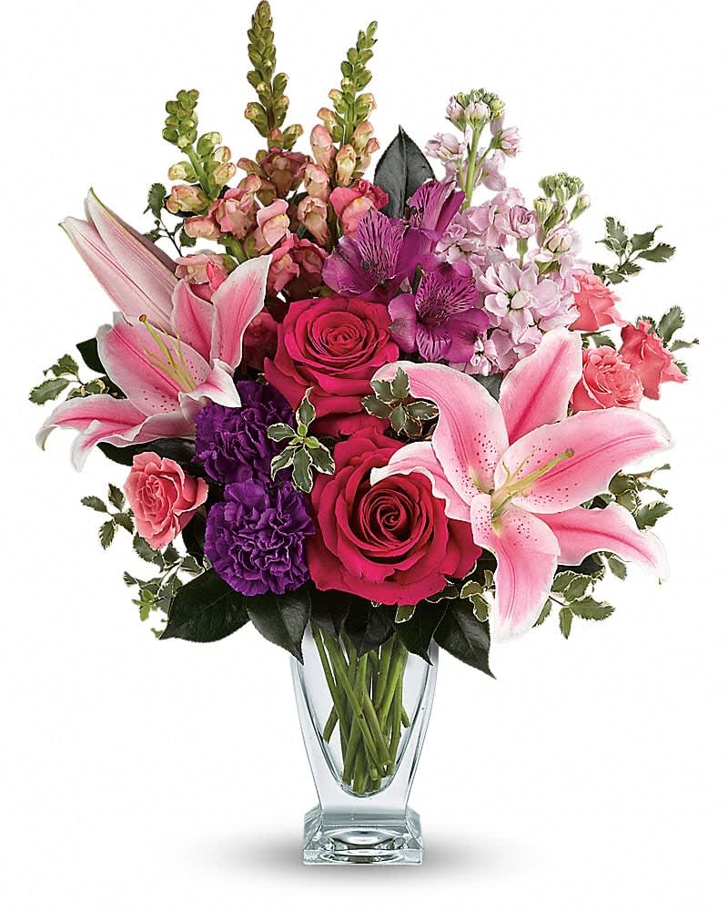 Teleflora's Morning Meadow Bouquet Teleflora's Morning Meadow Bouquet - Hand-delivered in a shapely glass vase, this sumptuous arrangement of roses and lilies is a lavish way to celebrate a special day - or surprise someone just because! Hot pink roses, pink spray roses, pink oriental lilies, purple alstroemeria, purple carnations, light pink stock and pink snapdragons are arranged with pitta negra and camellia leaves. Delivered in a clear Couture vase.