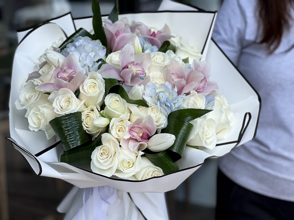 Pastel mix - handcrafted bouquet  - Mixed arrangement with roses, cymbidium orchids and tulips  Vase not included 