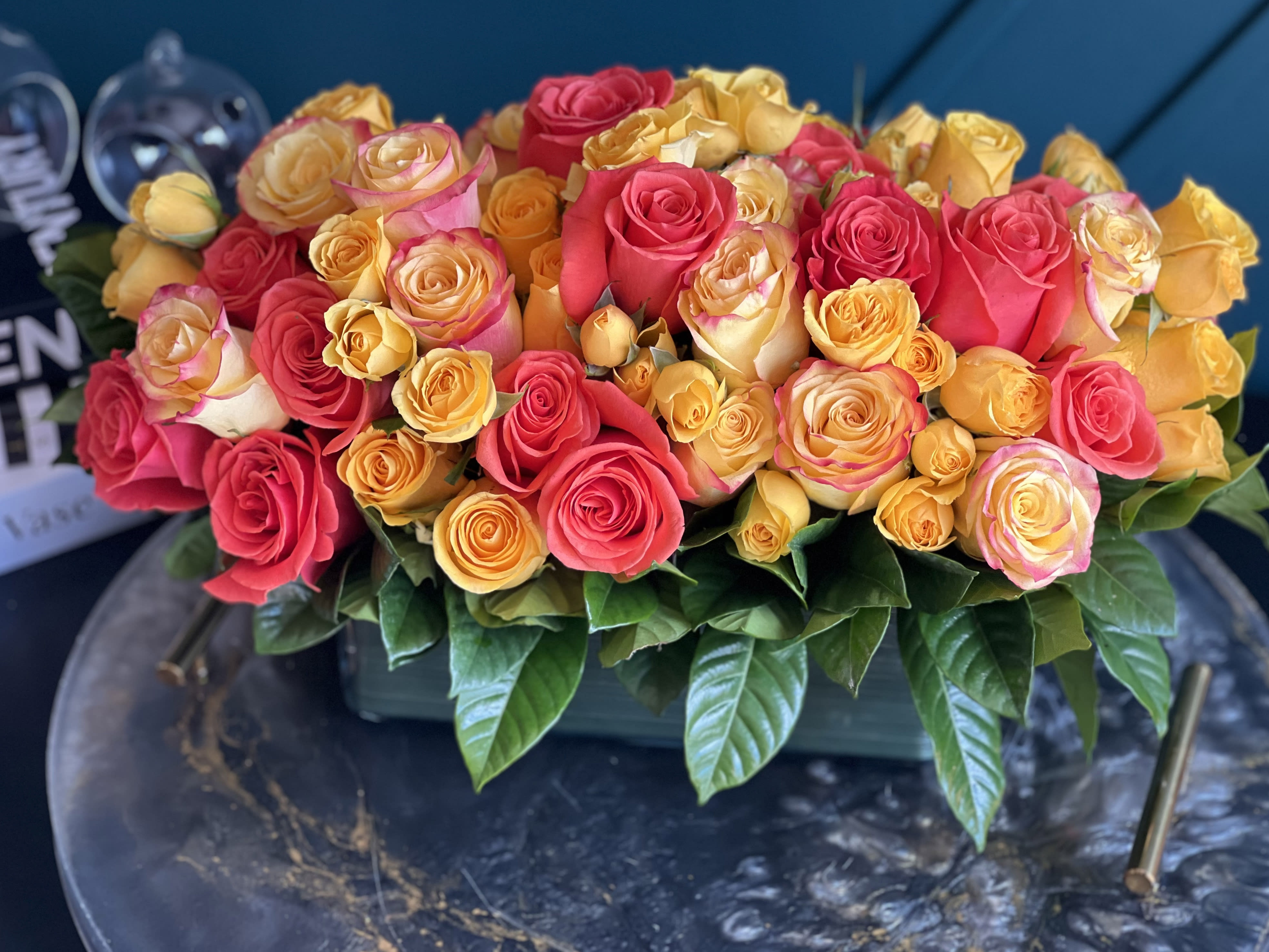Pallet of color- vase design with roses - Pallet of color- vase design with roses Mixed color roses design with 60 yellow, orange and bi-color roses with spray roses in low vase