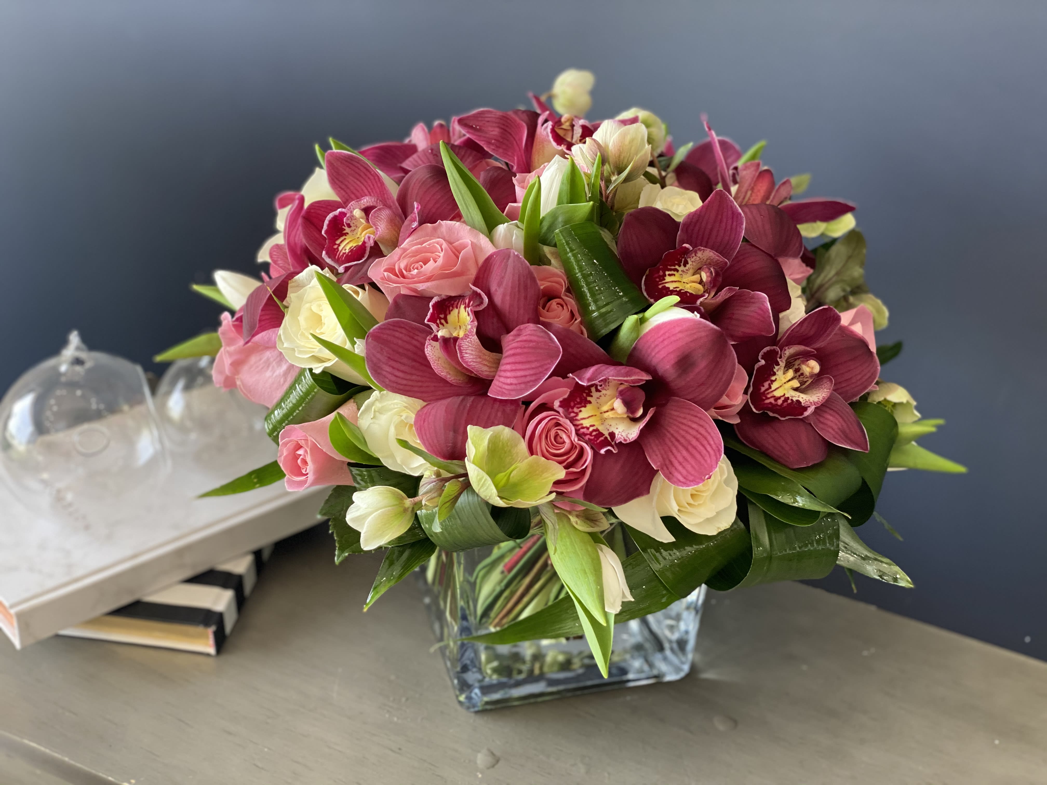 Orchids beauty  - Mixed arrangement in a cube vase with roses, tulips and cymbidium orchids 