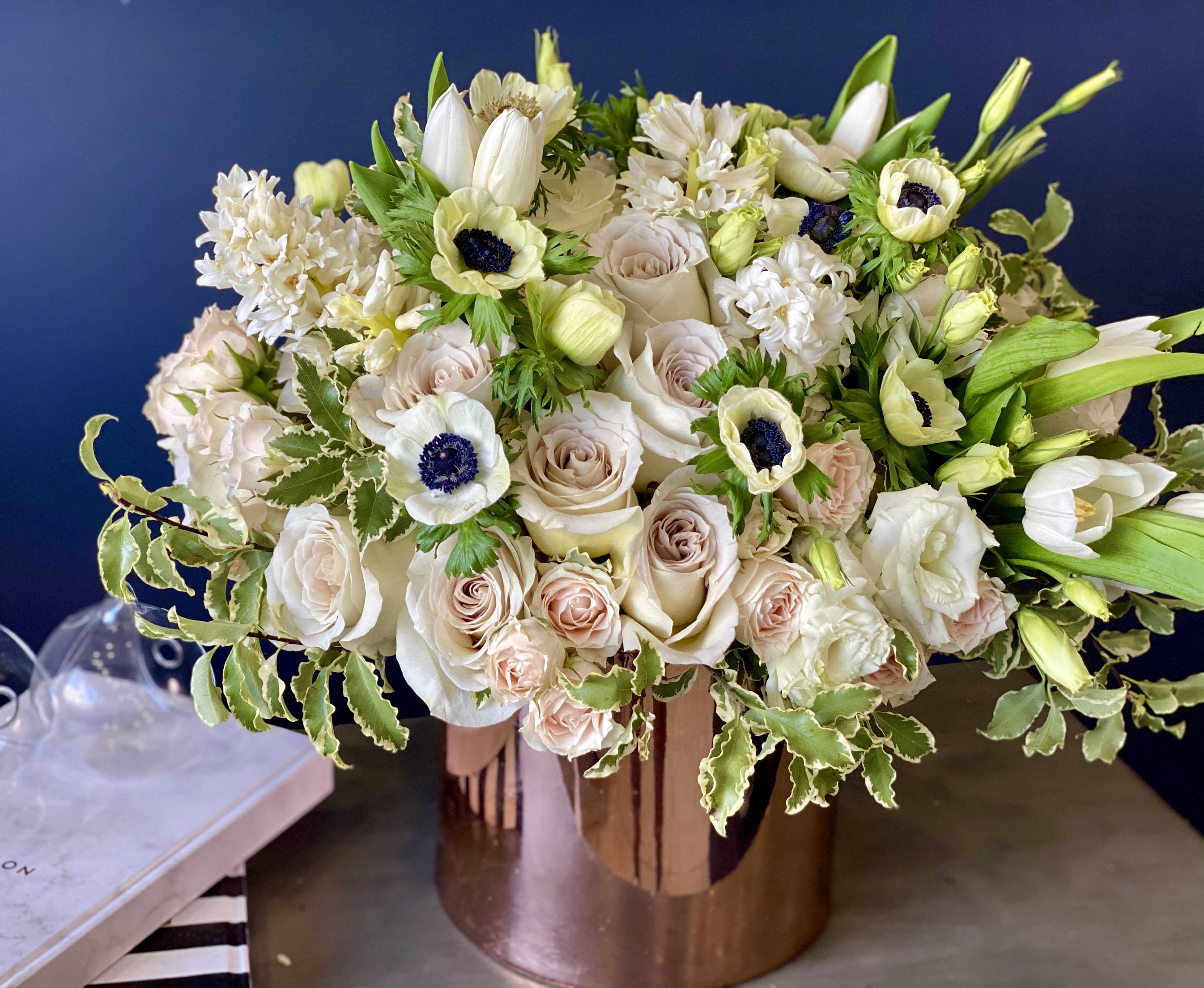 Vased arrangement in pastel and white colors  - Vased arrangement in pastel and white colors with roses, spray roses, anemones and mixed flowers 