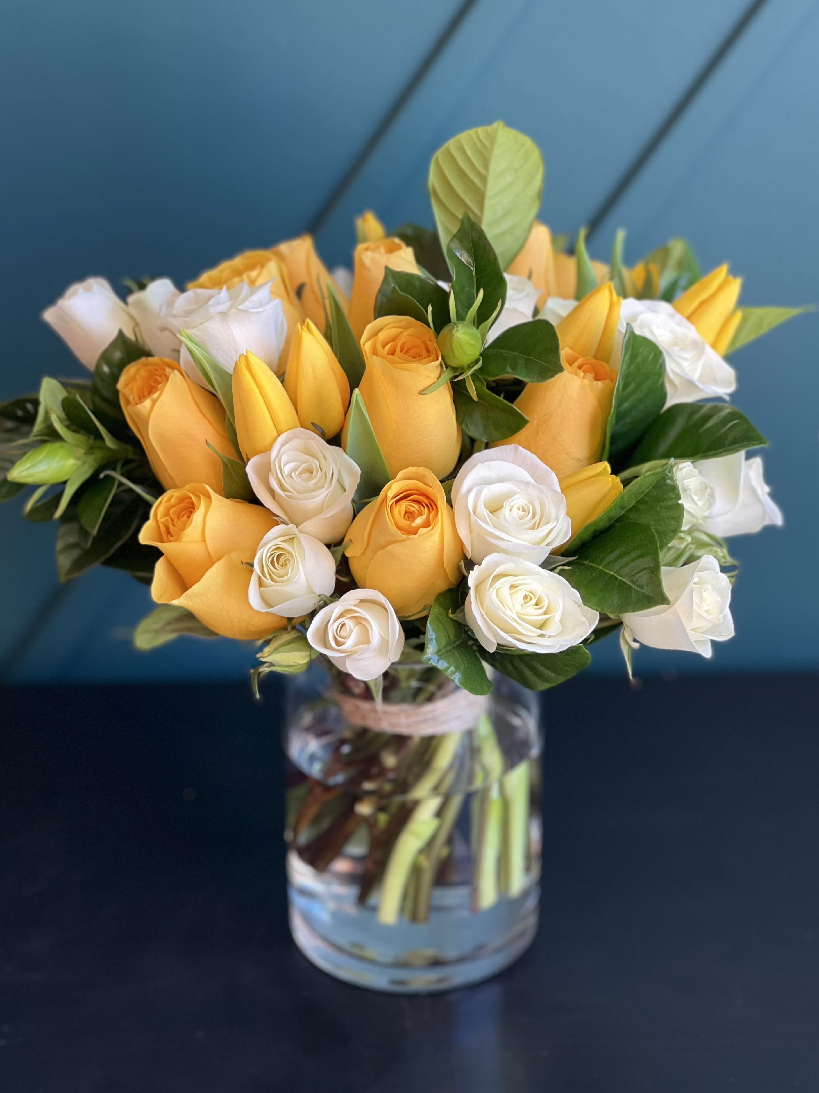 Bright Arrangement in a vase - Bright Arrangement in a vase with yellow and white roses, tulips and greenery