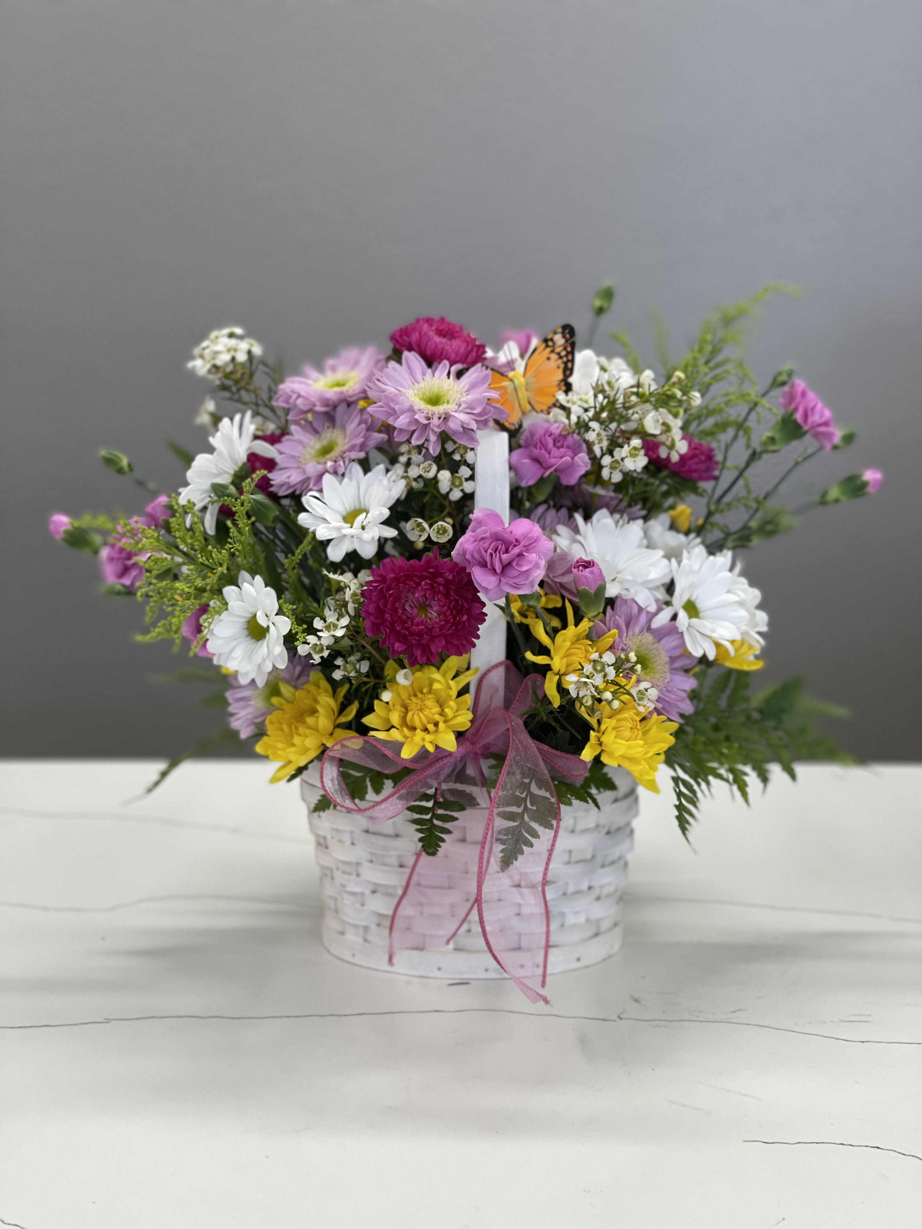 The Gardener's Basket The Gardener's Basket - Filled with happy spring flowers, this is the perfect gift for someone who wants to zhoosh up their place with life and light! Also, Hi little butterfly!