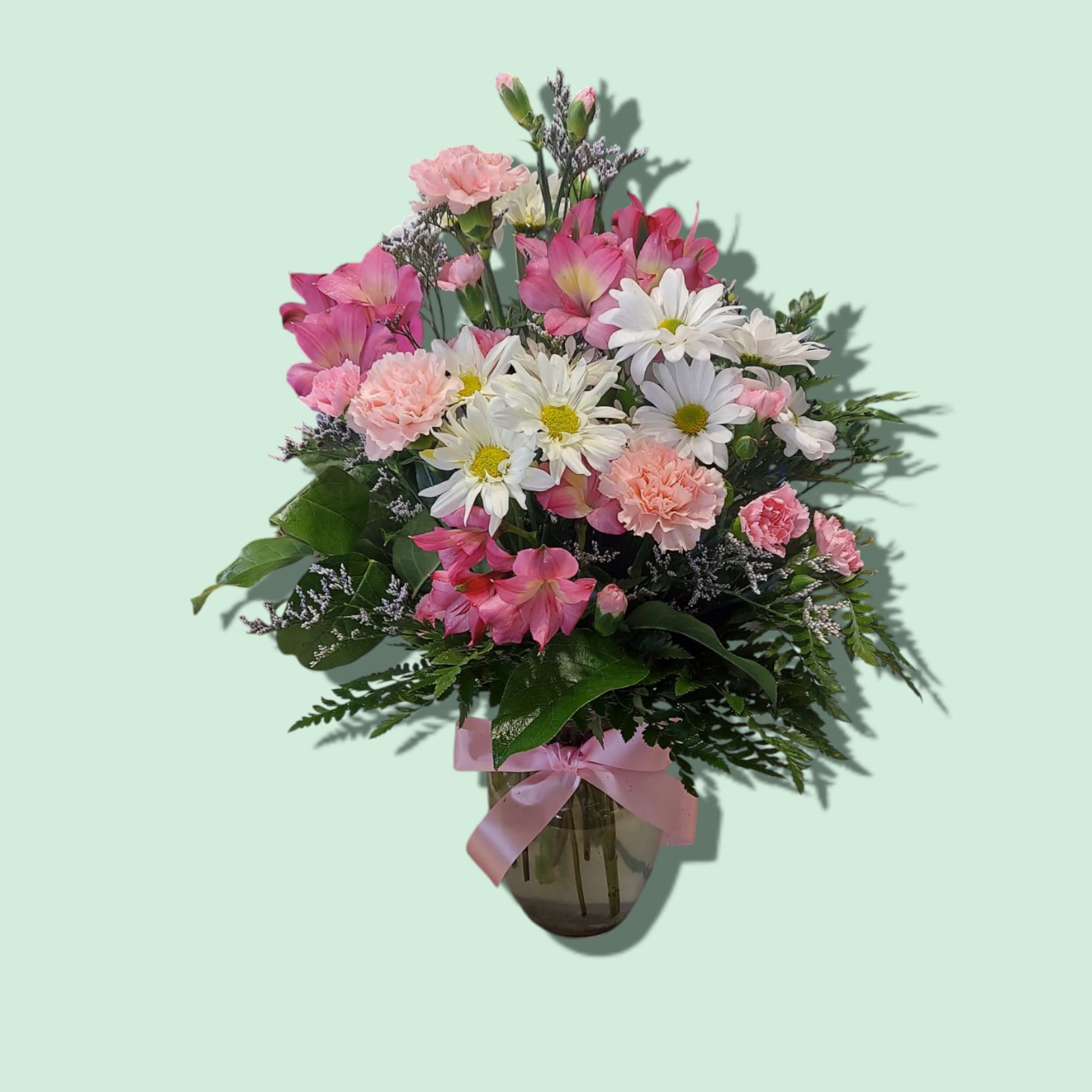 Sweet Tenderness Sweet Tenderness - The beautiful, one-sided, bouquet includes pink alstroemeria, pink carnations, hot pink miniature carnations, white daisy chrysanthemums and limonium, accented with assorted greenery. Delivered in a clear glass rose vase. Approximately 15 1/2" W x 18" H