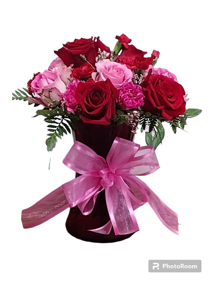 Blush &amp; Bloom Delight - Brighten any space with our Blush &amp; Bloom Delight vase arrangement, a stunning bouquet that marries the romance of red roses with the playful charm of pink carnations. Tied together with a delicate pink ribbon, this floral masterpiece is not just a feast for the eyes but also a delightful embrace of nature's finest hues. Perfect for any occasion, it whispers sweet nothings of love and joy, making it an ideal gift or a lovely treat for yourself!