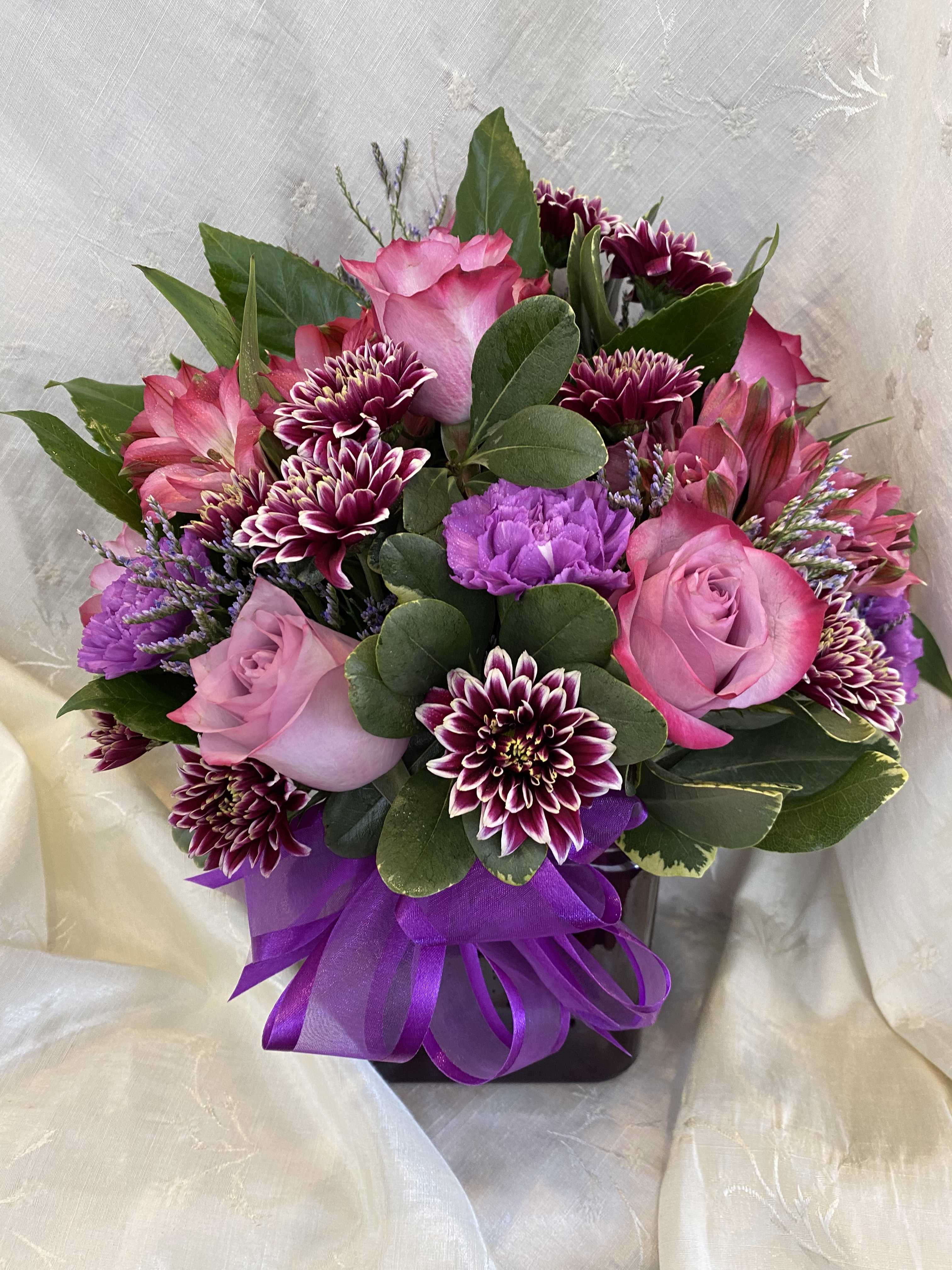 Plum Krazy - This is the perfect arrangement for the purple lover out there. This will really show someone how much you care! With roses, carnations, alstroemeria and daisies this is the best gift for anyone!