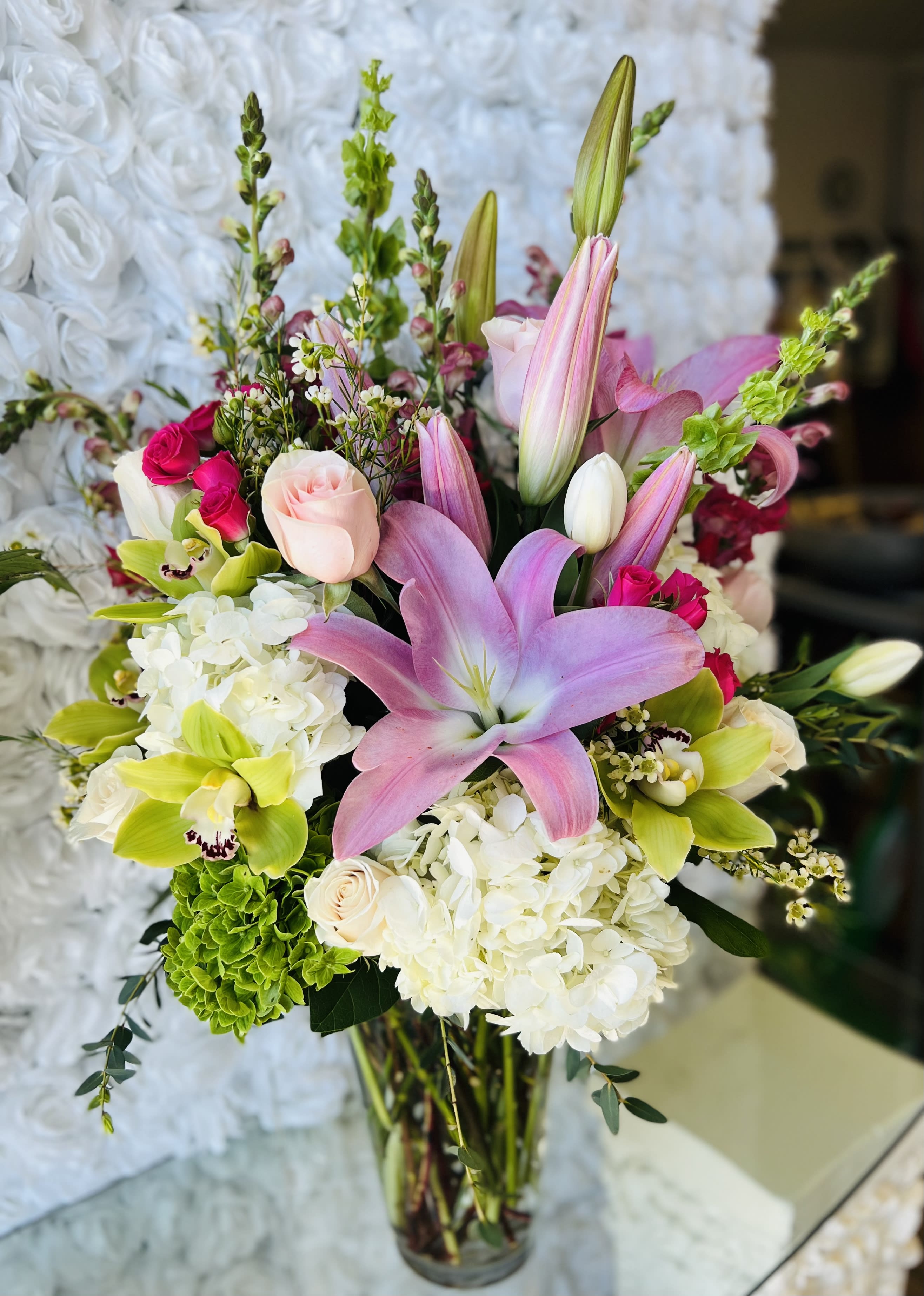Scottsdale’s Spring Time  - Blush pinks and soft blues welcome the spring season. Upgrades go in same vase for a fuller look, premium is in a bigger vase and more Flowers. 