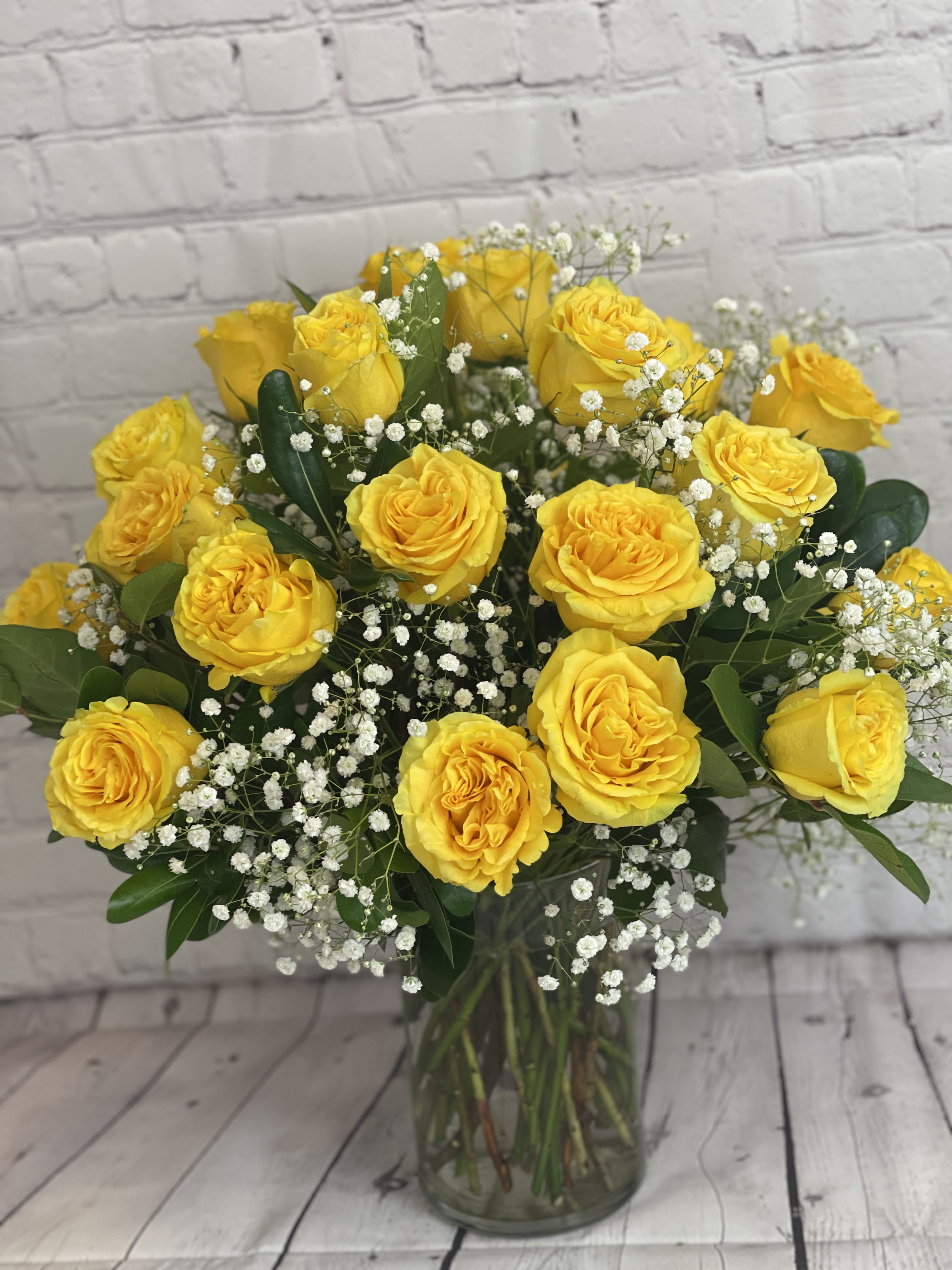 2 dozen yellow roses by Blooming Canyon  - Celebrate beautiful moments with a timeless bouquet of a dozen vibrant yellow roses with baby's breath. Known for their cheerful hue, yellow roses are the perfect symbol of friendship, happiness, and new beginnings. Each rose is hand-selected for its beauty and freshness, ensuring your loved ones receive a gift that radiates warmth and positivity. Whether for a birthday, anniversary, or to brighten someone's day, this bouquet from Blooming Canyon offers a thoughtful and lasting gesture.  Carefully arranged and delivered, the yellow roses will bring sunshine to any occasion.