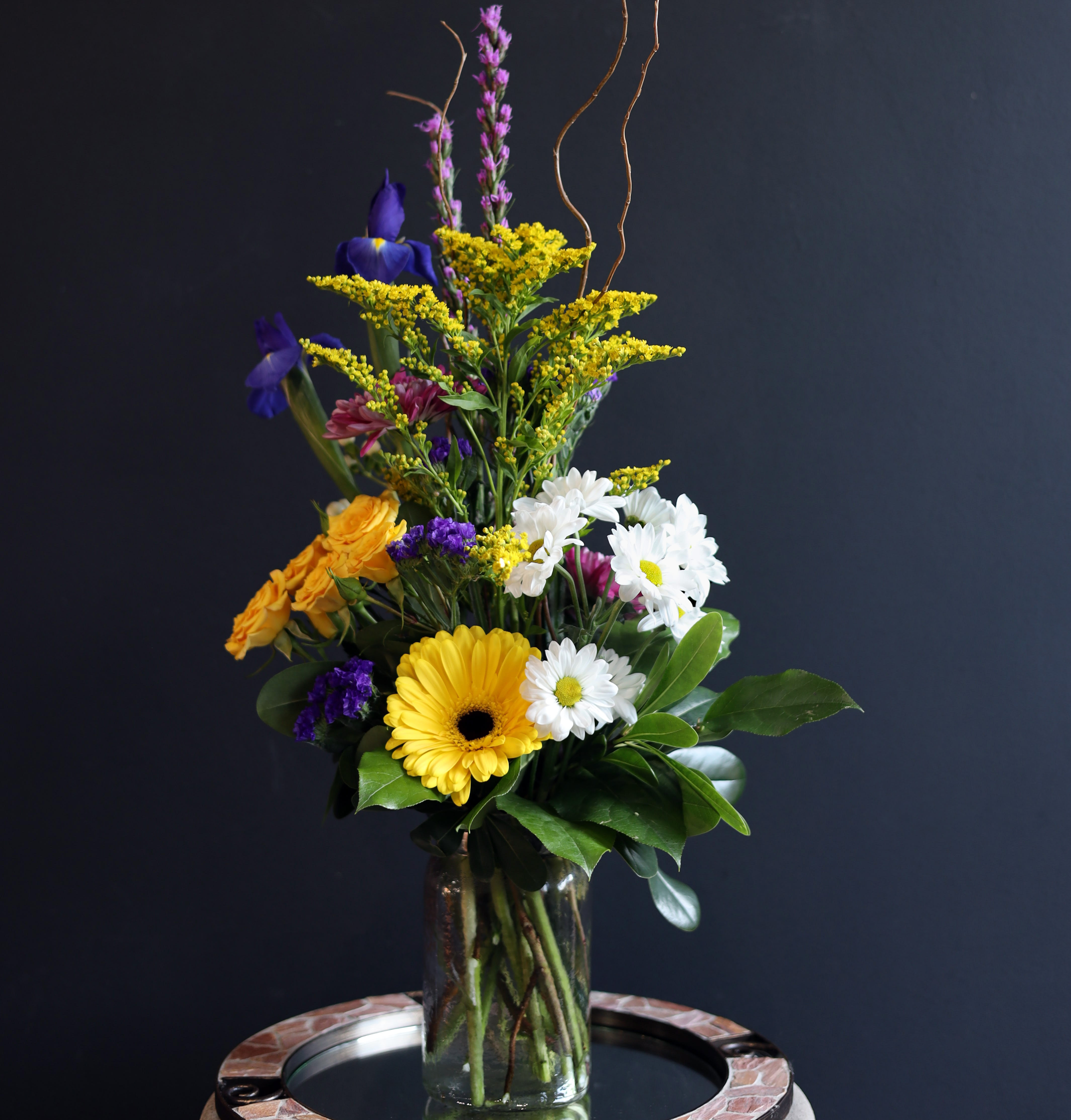 Just My Type - Looking for something with a little less than the traditional Valentine's Day colors this year? Well this is just your type! A purple mason jar filled with yellow spray roses, white daisies, hypericum, a gerbera daisy and more!