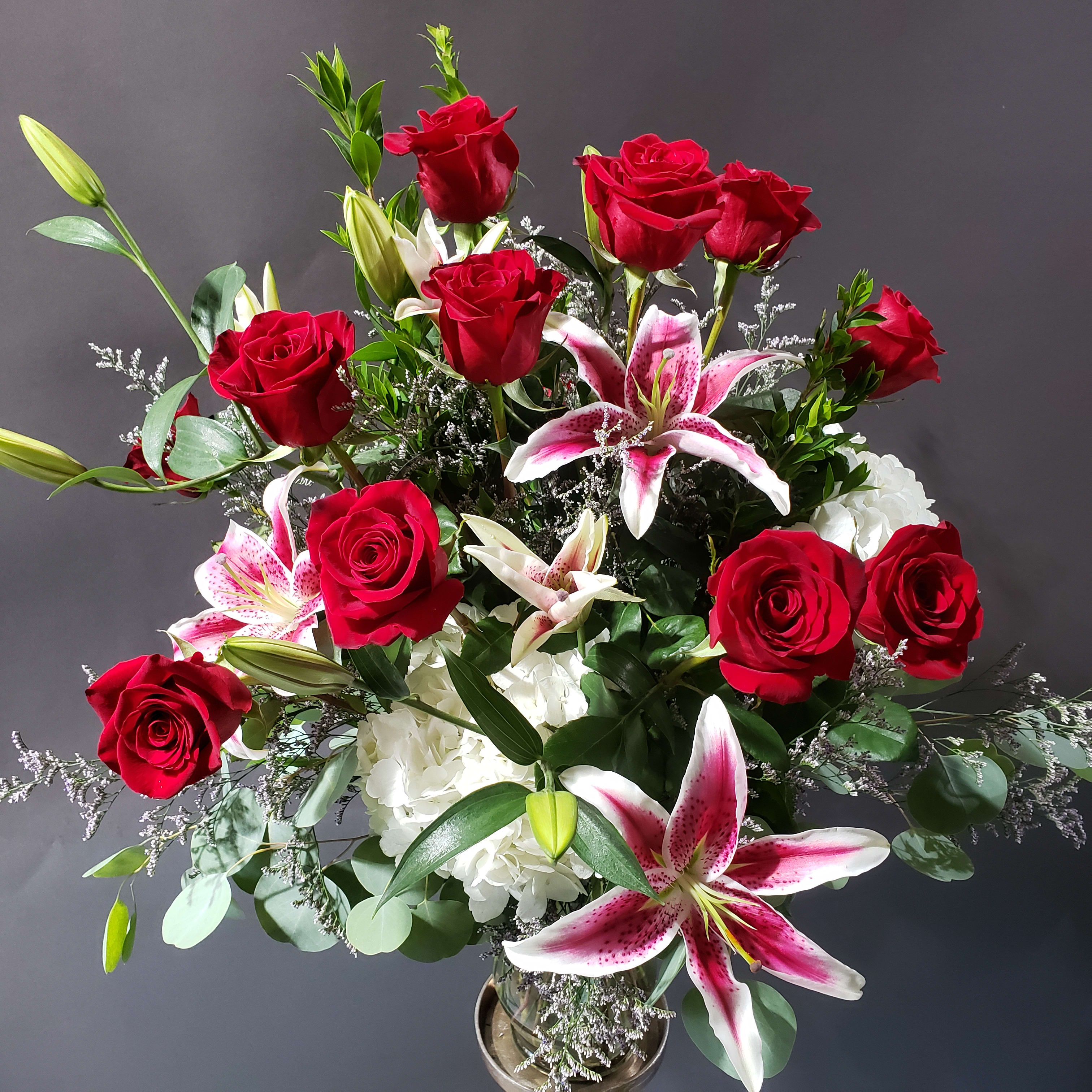 WOW! Dozen Roses and More - Featuring brilliant stargazer lilies and a dozen red roses is sure to make your significant other say WOW! 