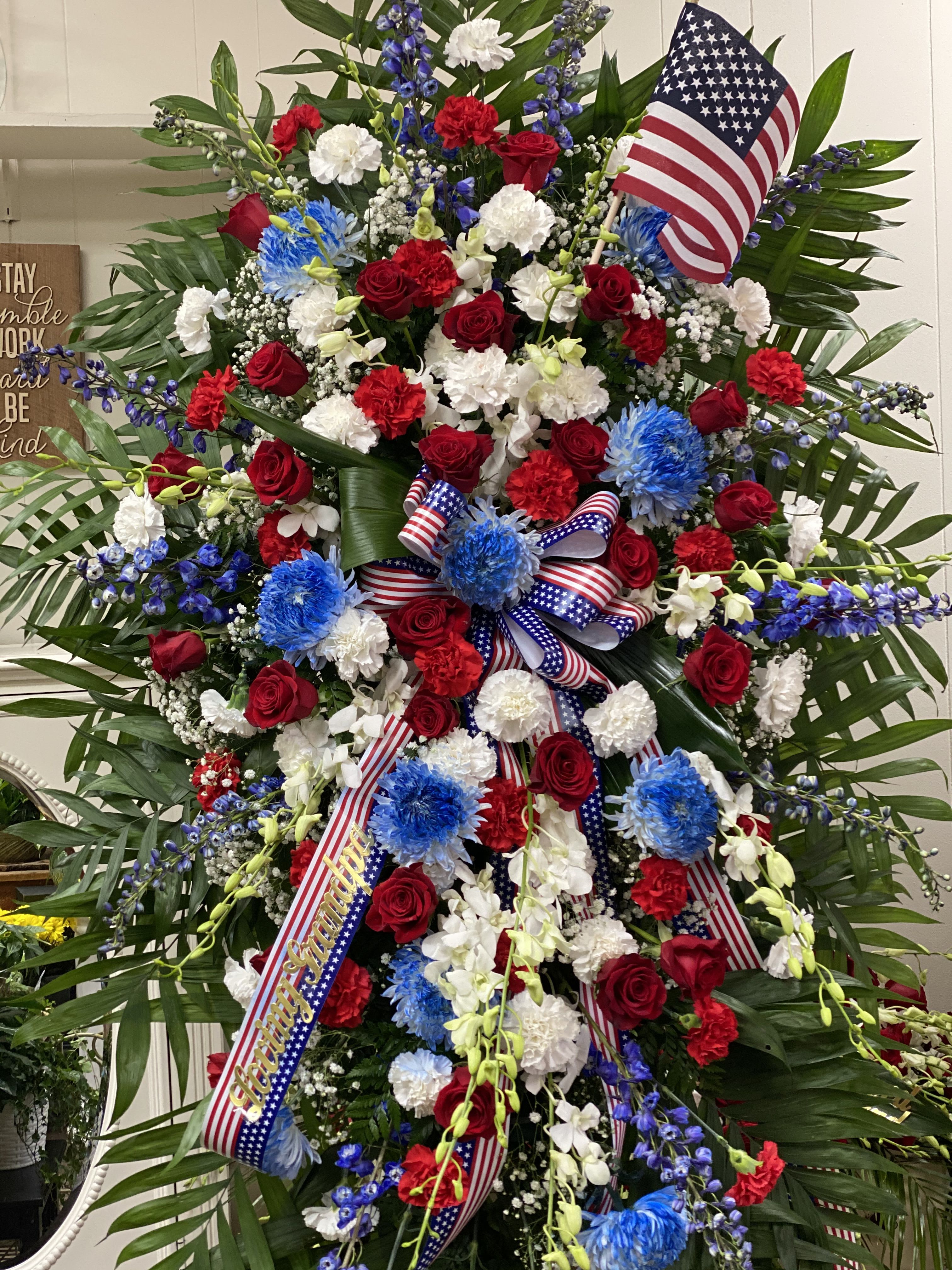 American Freedom Spray - Standing tall, proud and patriotic, this dazzling free-standing spray is like a fireworks display made of graceful flowers. Uniquely beautiful, it's a lovely way to honor a great loss. 