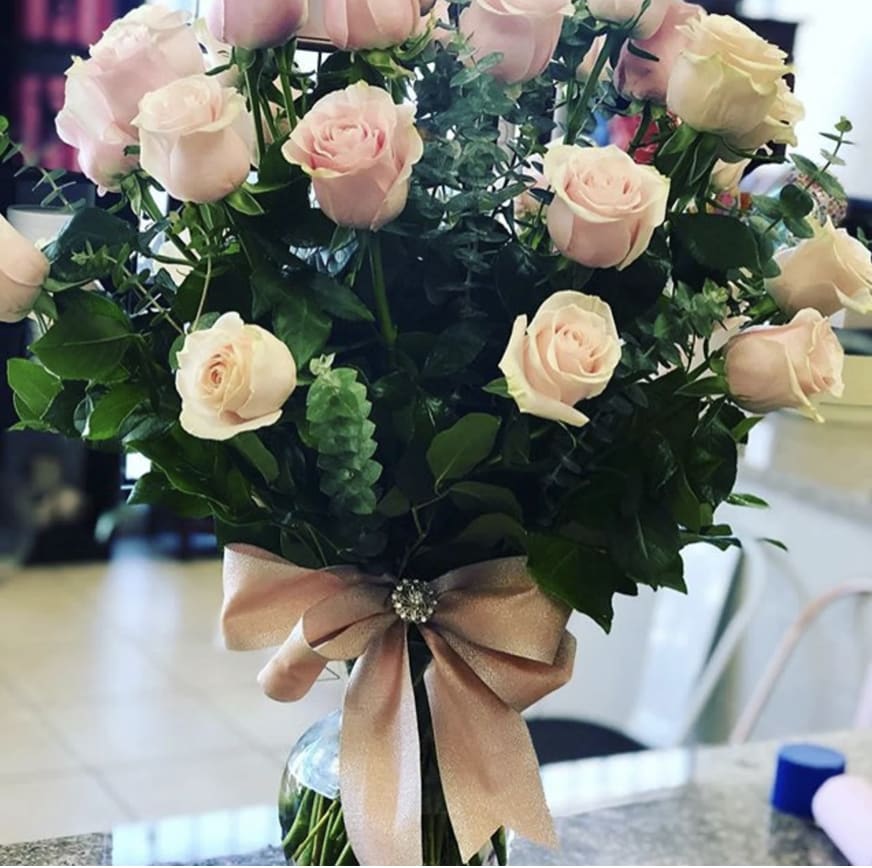 Make Me Blush Make Me Blush - Arrangement includes two dozen lovely pink roses with a stylish bow.