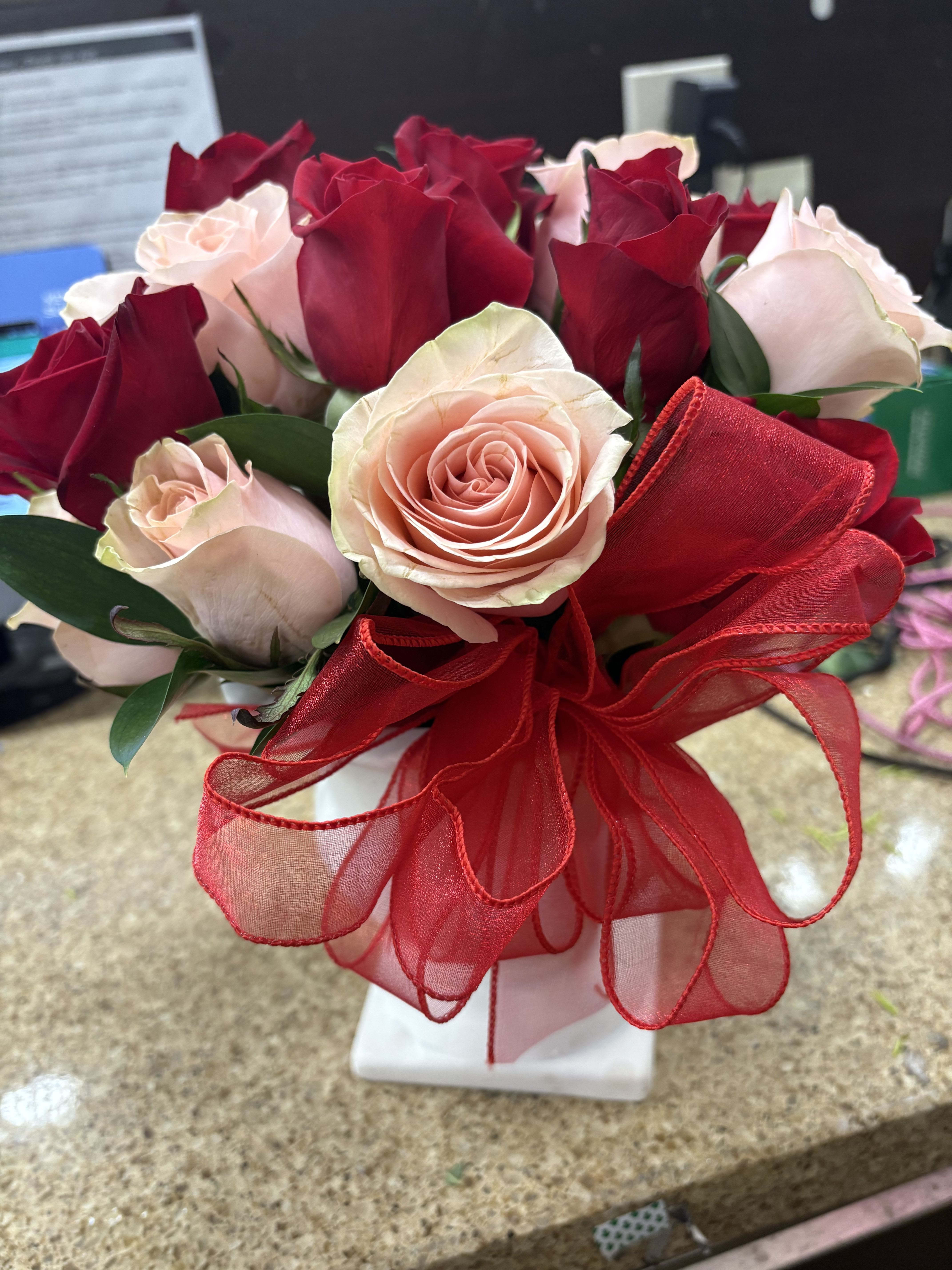 pretty roses - greenery with a dozen red and a dozen light pink or peach roses on a short vase