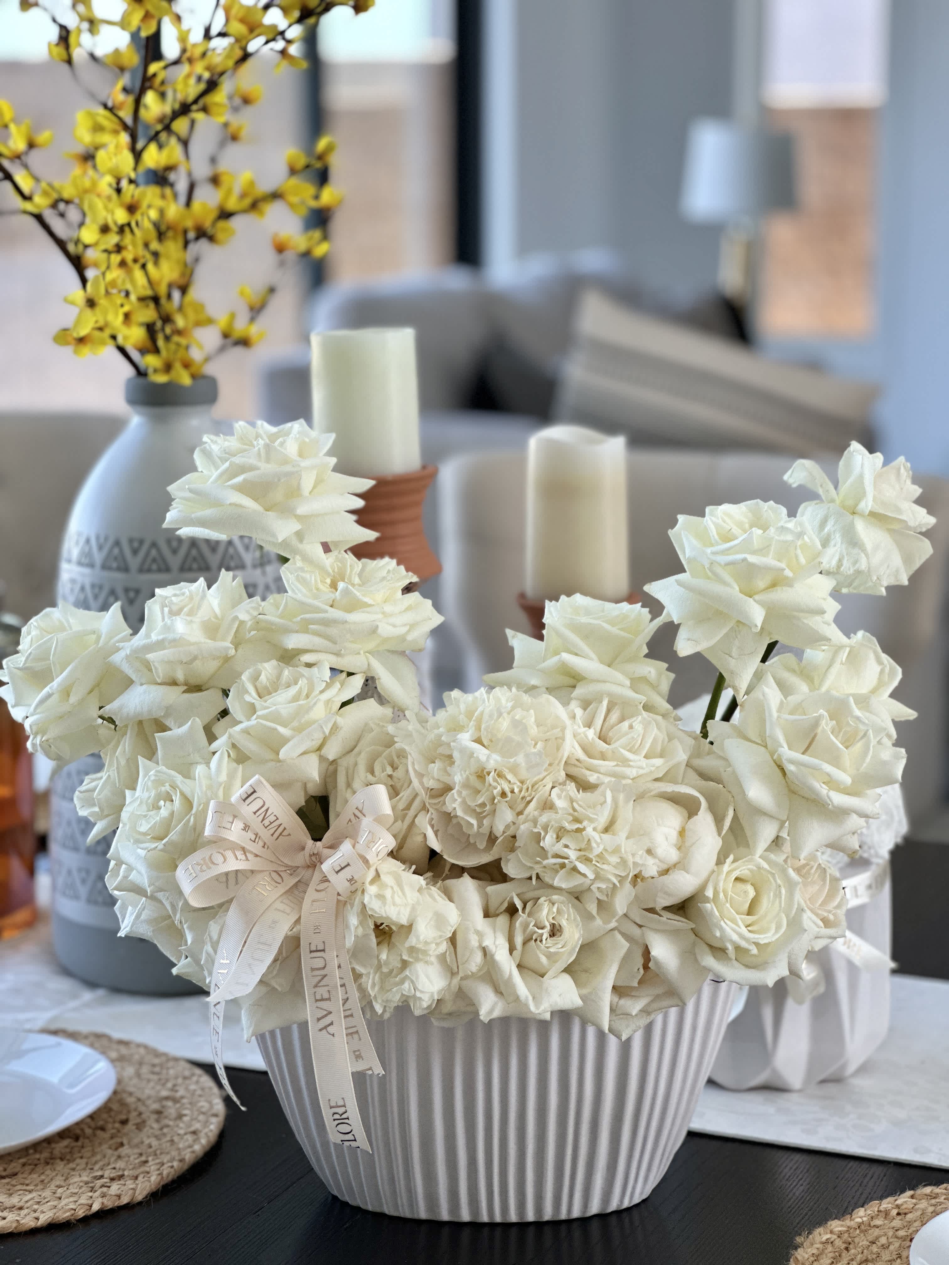 Ivory Elegance - A sophisticated white rose arrangement nestled in a chic vase, perfectly balancing elegance with modern simplicity. This exquisite floral display is not just a gift but a timeless home decor accessory, adding grace and serenity to any space. 