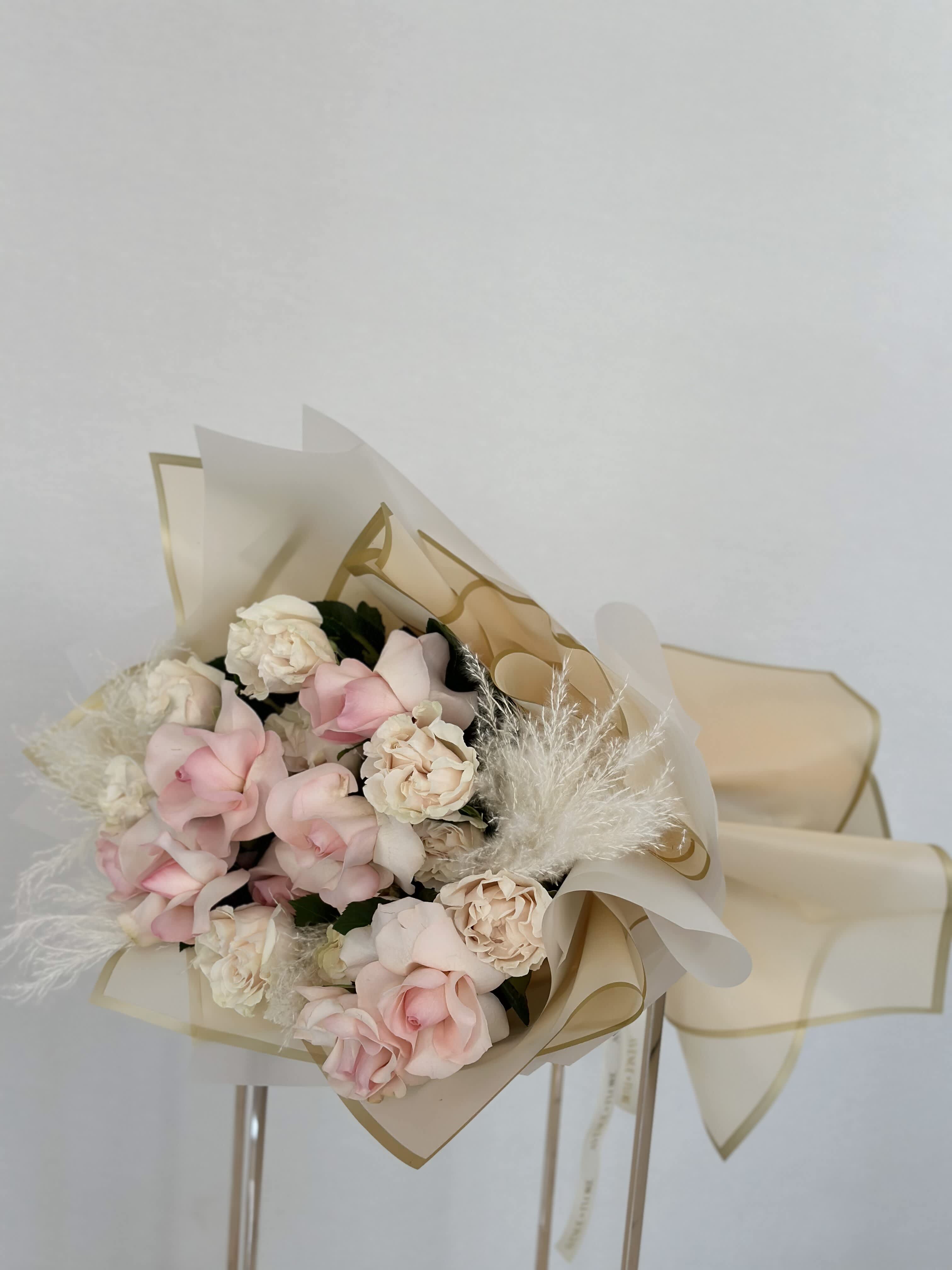 Sweet Whisper Bouquet - Introducing 'Sweet Whisper,' a tender bouquet that embodies the softness and grace of a gentle breeze. Delicately crafted with light pink garden roses and blush pink roses, each bloom whispers secrets of affection and tenderness. 